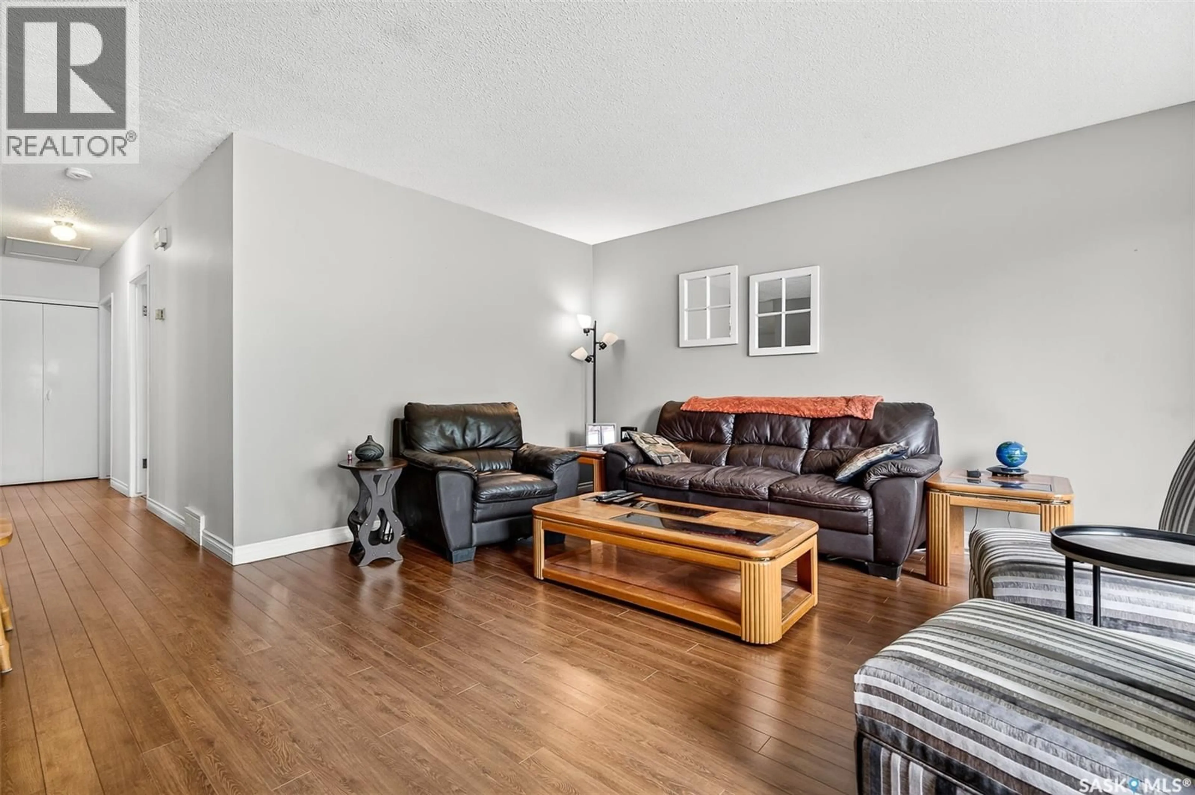 Living room with furniture, wood/laminate floor for 1345 QUEEN CRESCENT, Moose Jaw Saskatchewan S6H3G5