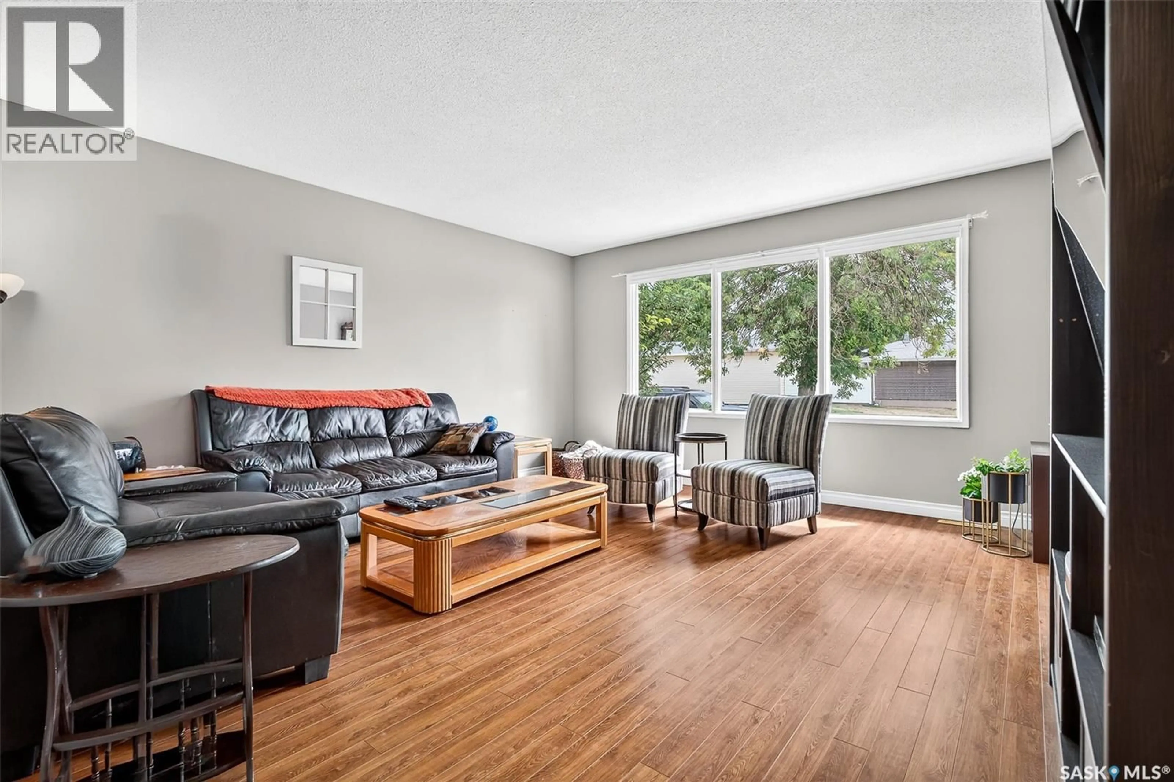 Living room with furniture, wood/laminate floor for 1345 QUEEN CRESCENT, Moose Jaw Saskatchewan S6H3G5