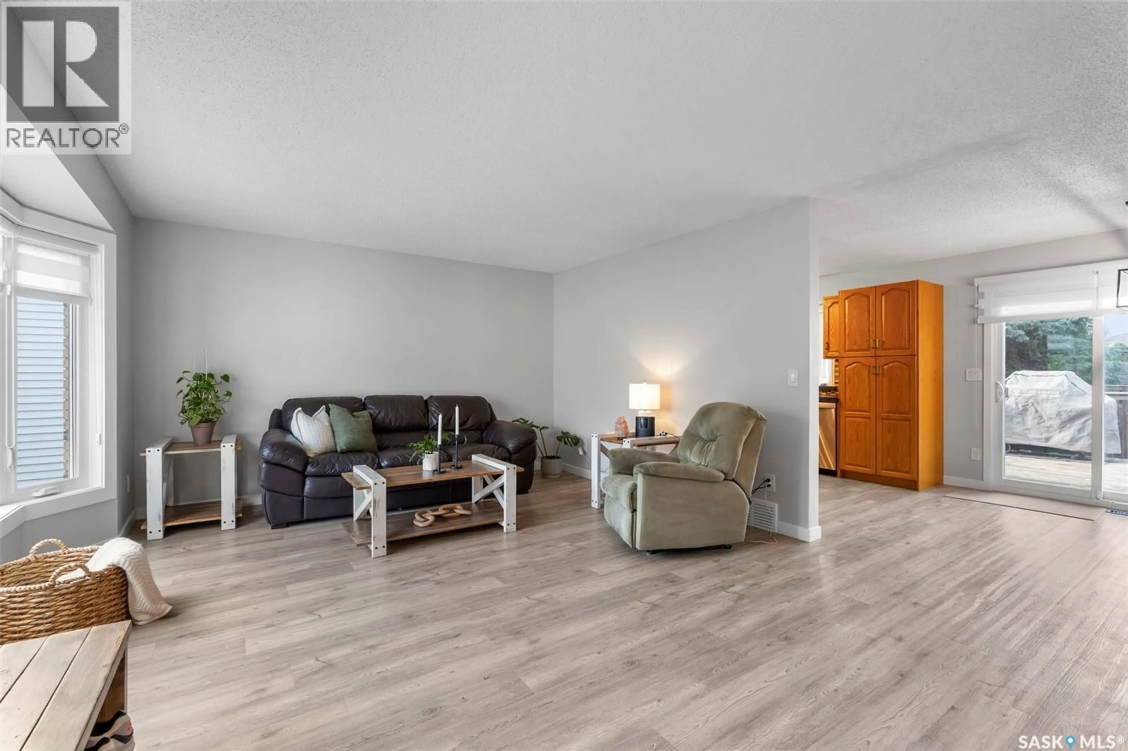 Living room with furniture, wood/laminate floor for 446 PEBERDY CRESCENT, Saskatoon Saskatchewan S7K7N3