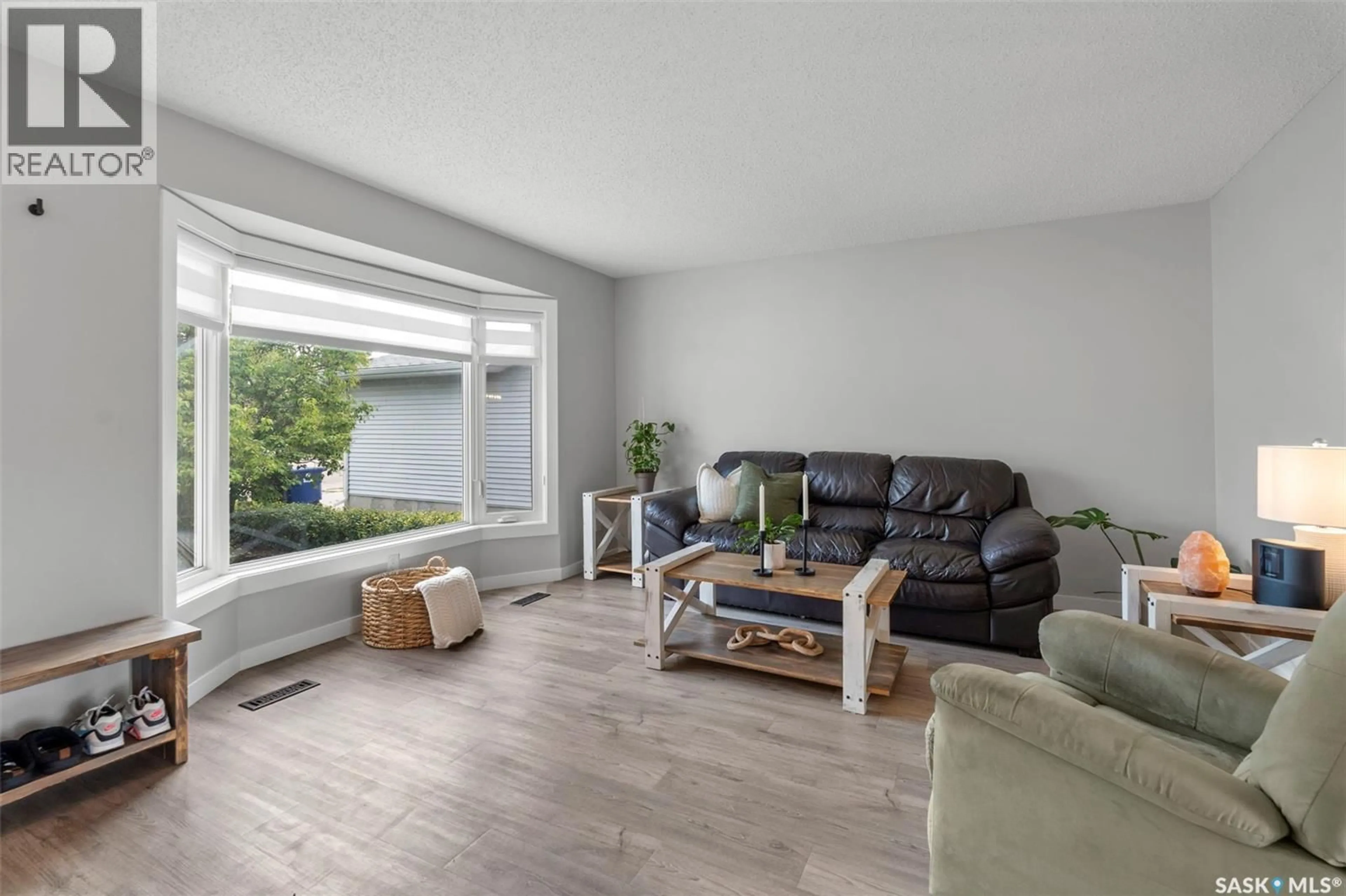 Living room with furniture, wood/laminate floor for 446 PEBERDY CRESCENT, Saskatoon Saskatchewan S7K7N3