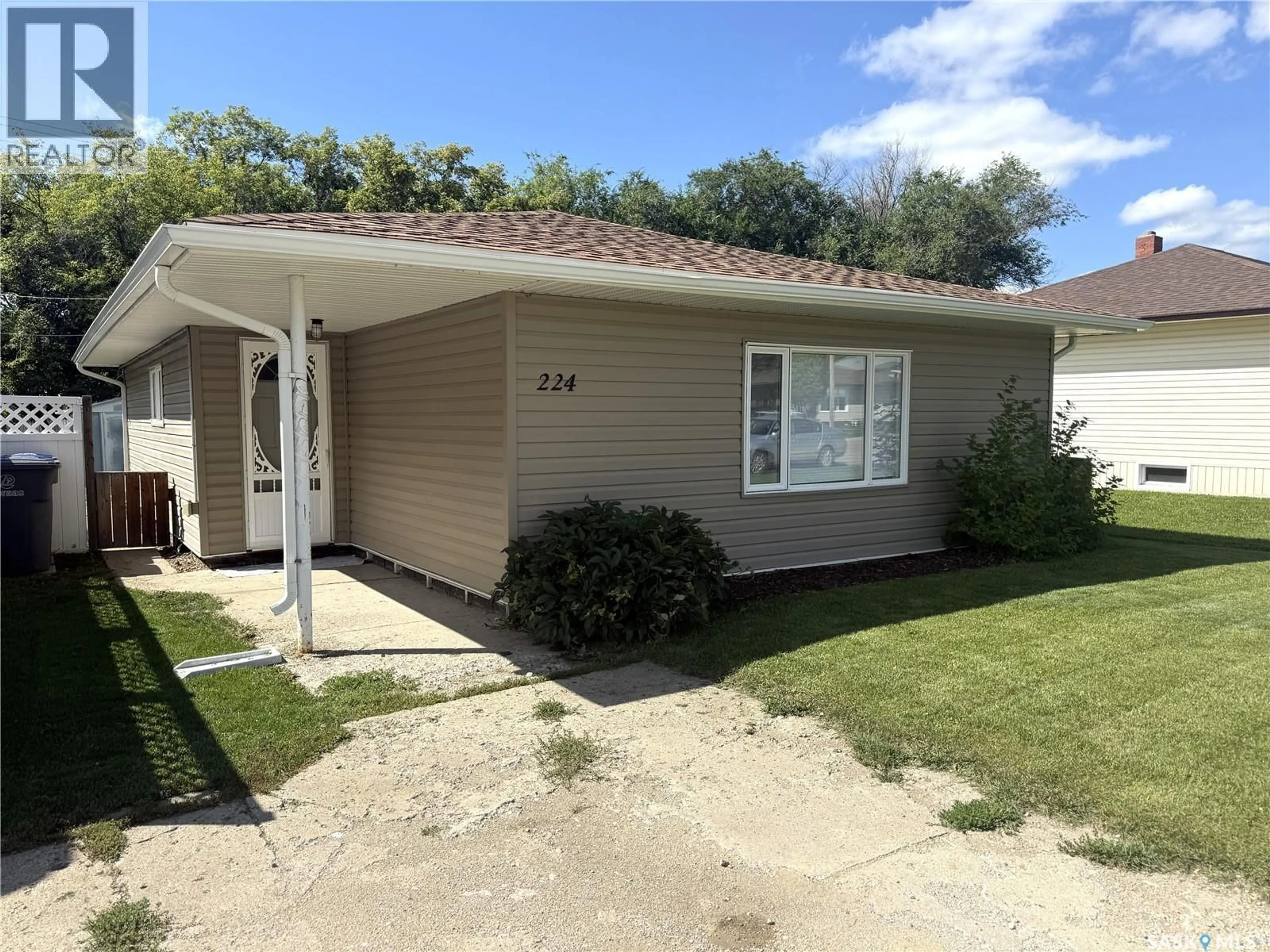 Home with vinyl exterior material, street for 224 THOMSON STREET, Outlook Saskatchewan S0L2N0