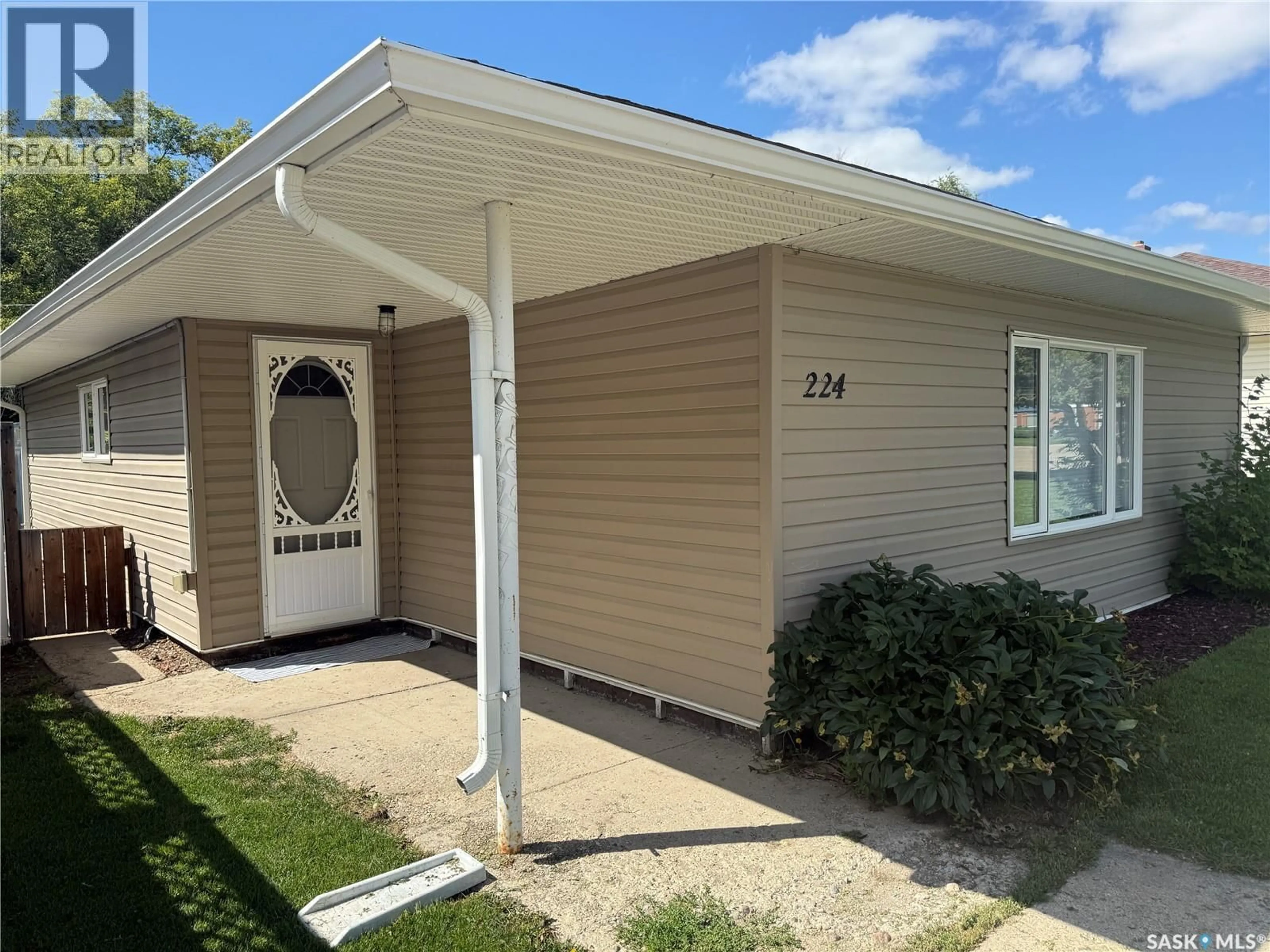 Home with vinyl exterior material, street for 224 THOMSON STREET, Outlook Saskatchewan S0L2N0