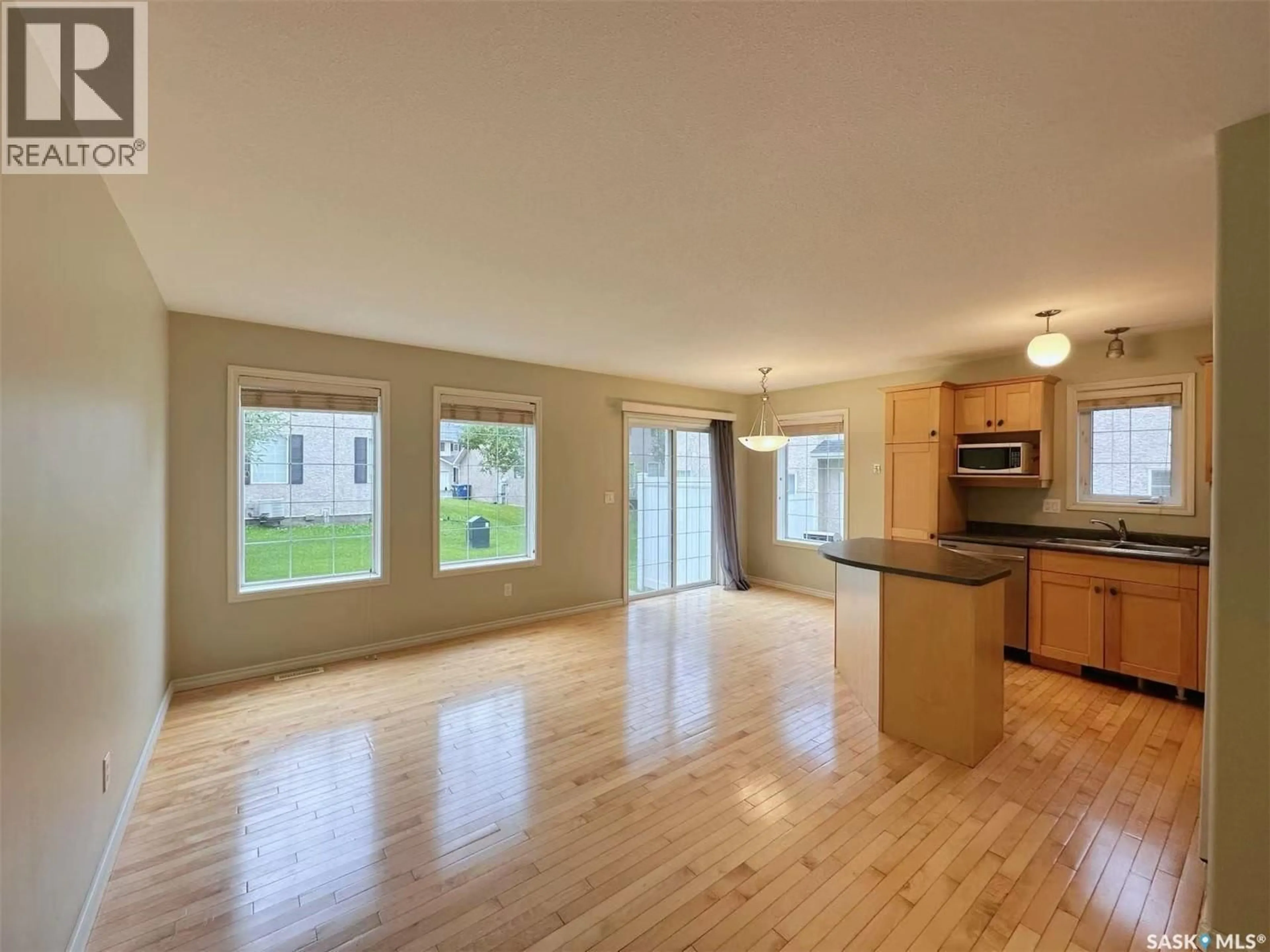 Open concept kitchen, wood/laminate floor for 32 127 BANYAN CRESCENT, Saskatoon Saskatchewan S7V1G5