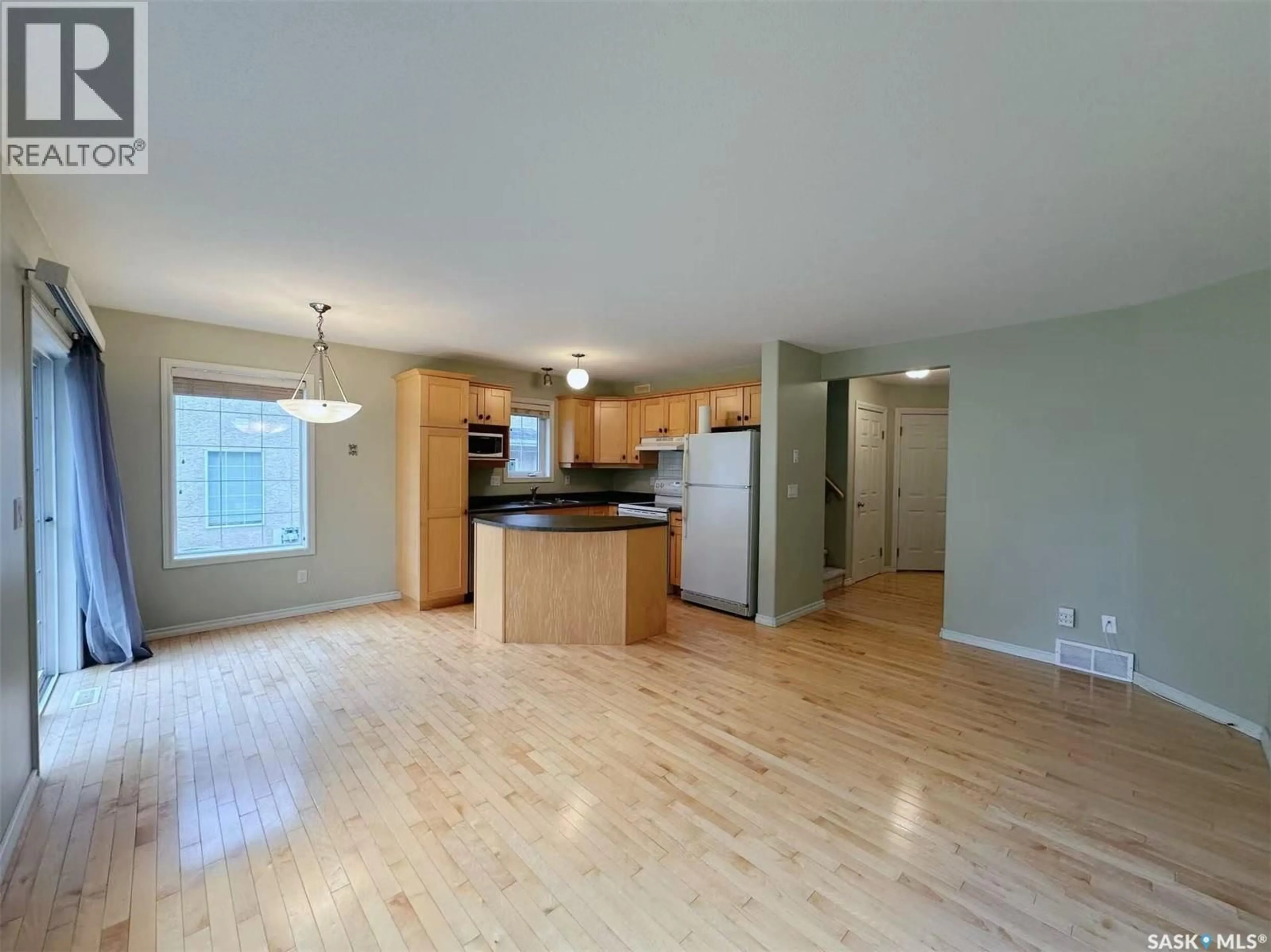 Open concept kitchen, wood/laminate floor for 32 127 BANYAN CRESCENT, Saskatoon Saskatchewan S7V1G5