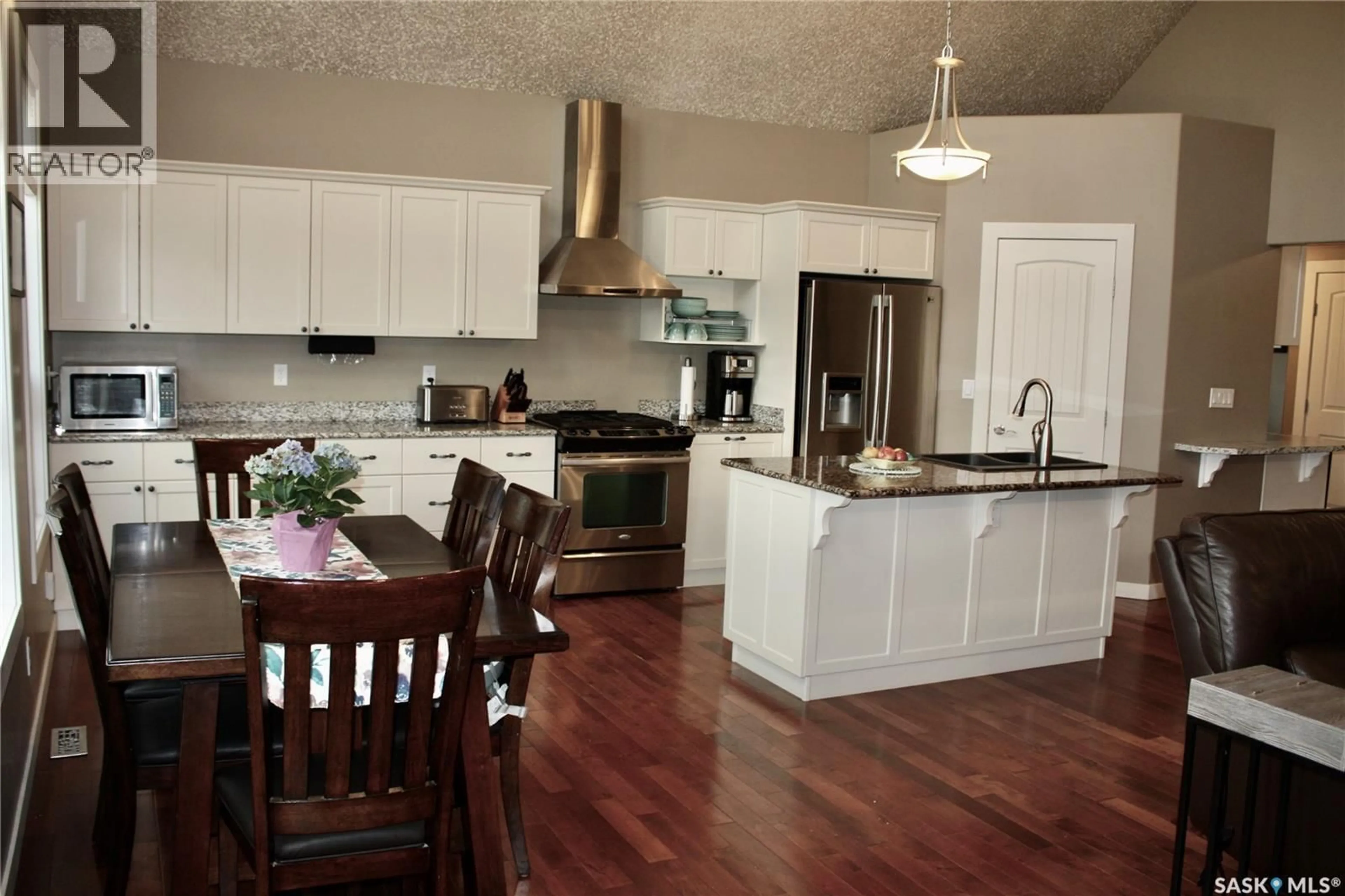 Open concept kitchen, wood/laminate floor for 212 JURA STREET, Colonsay Saskatchewan S0K0Z0