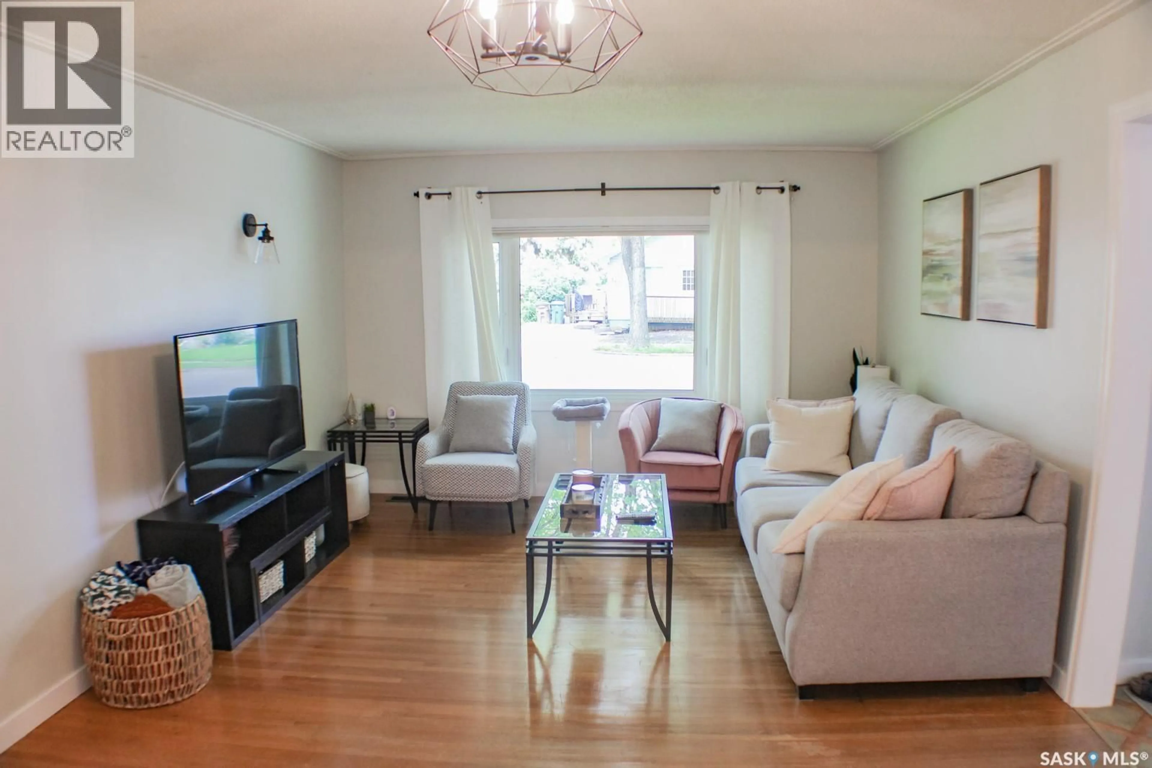 Living room with furniture, wood/laminate floor for E - 311 STOVEL AVENUE, Melfort Saskatchewan S0E1A0