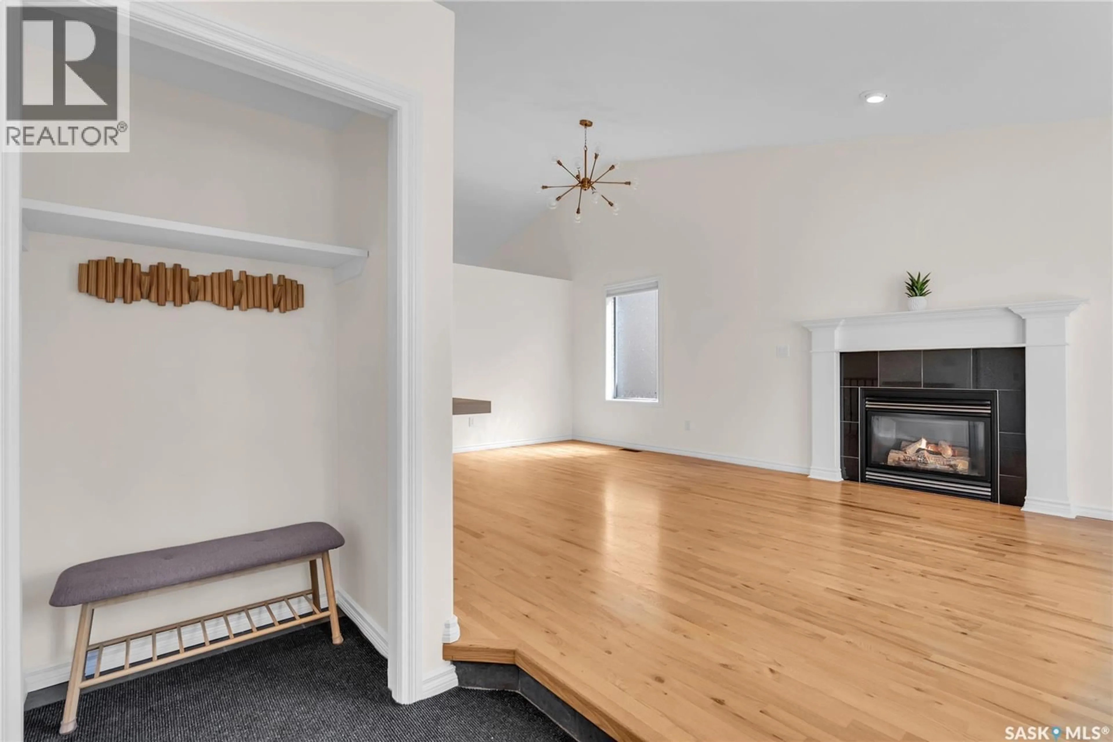 Living room with furniture, wood/laminate floor for 254 BEECHMONT CRESCENT, Saskatoon Saskatchewan S7V1C8
