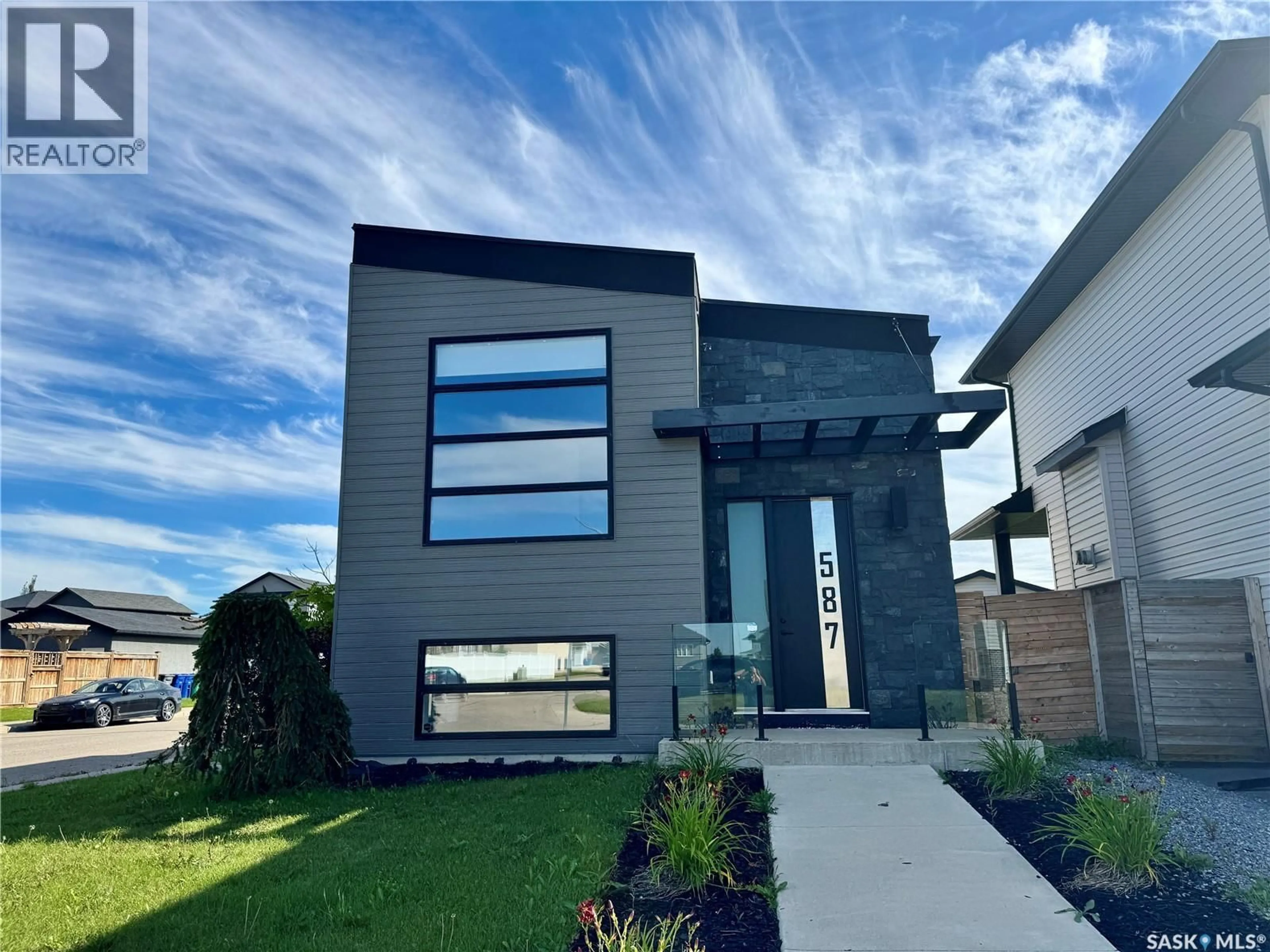 Home with vinyl exterior material, street for 587 KLOPPENBURG CRESCENT, Saskatoon Saskatchewan S7W0P1