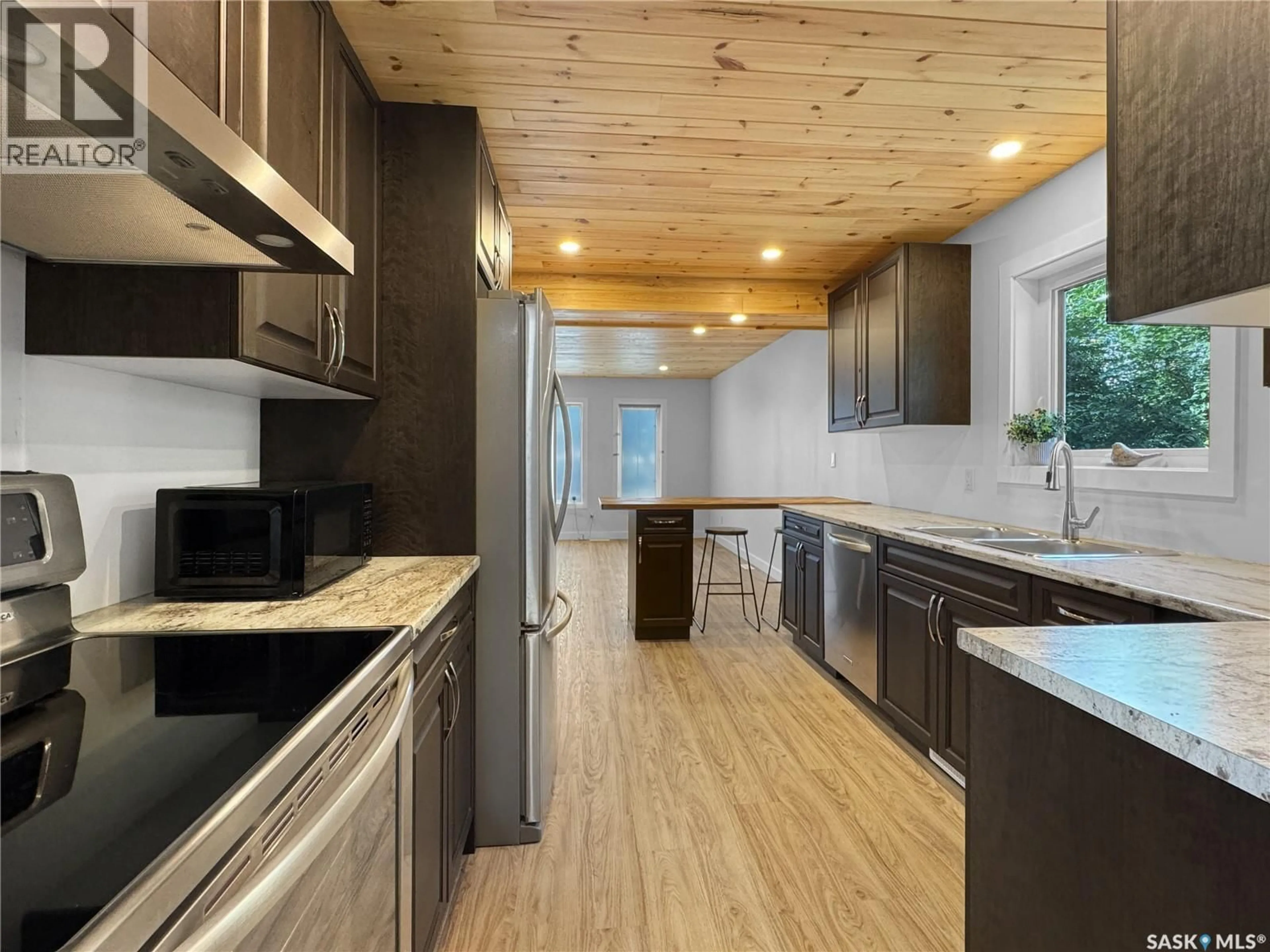 Open concept kitchen, wood/laminate floor for 1222 106TH STREET, North Battleford Saskatchewan S9A1X2