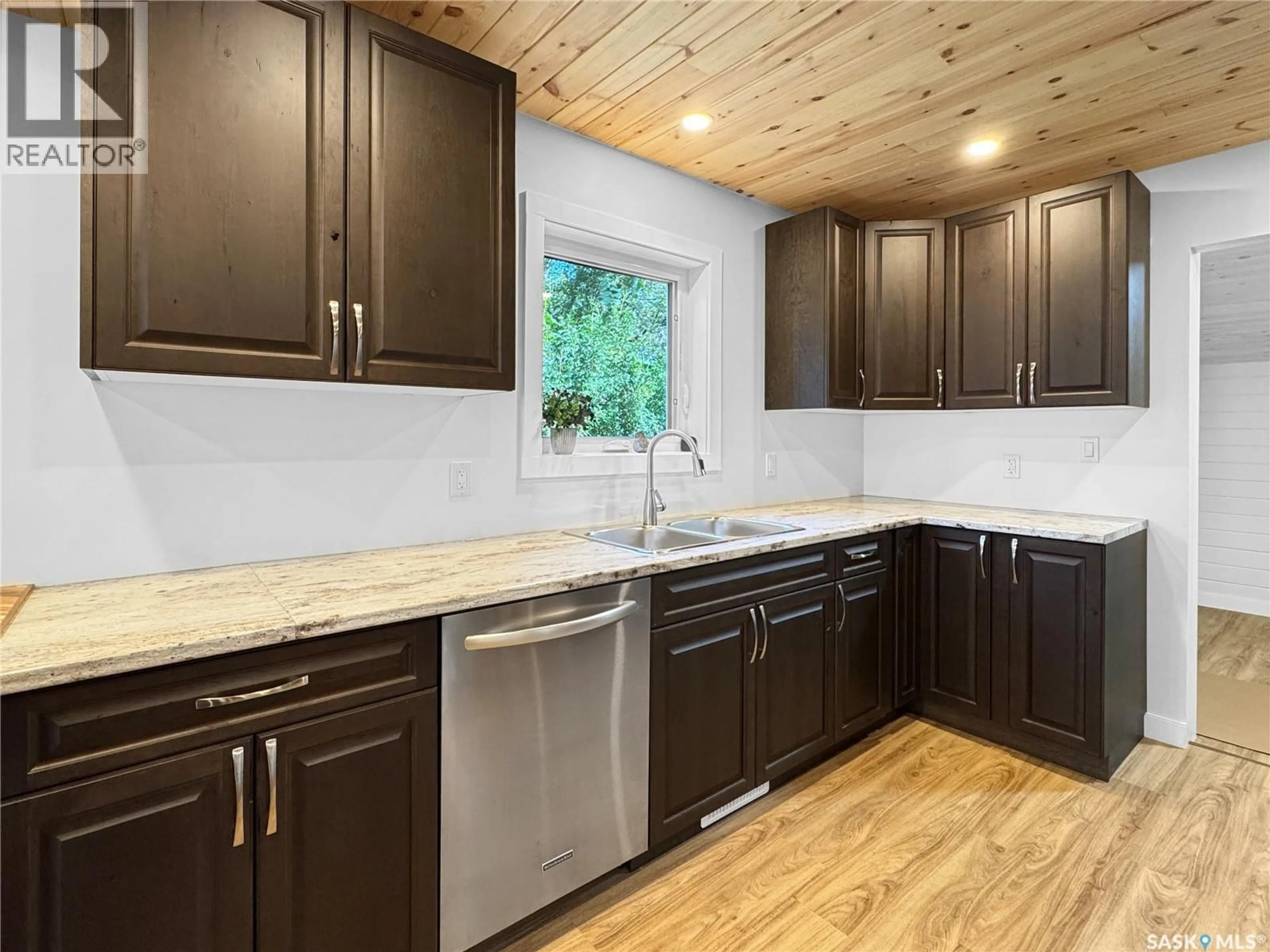 Open concept kitchen, wood/laminate floor for 1222 106TH STREET, North Battleford Saskatchewan S9A1X2