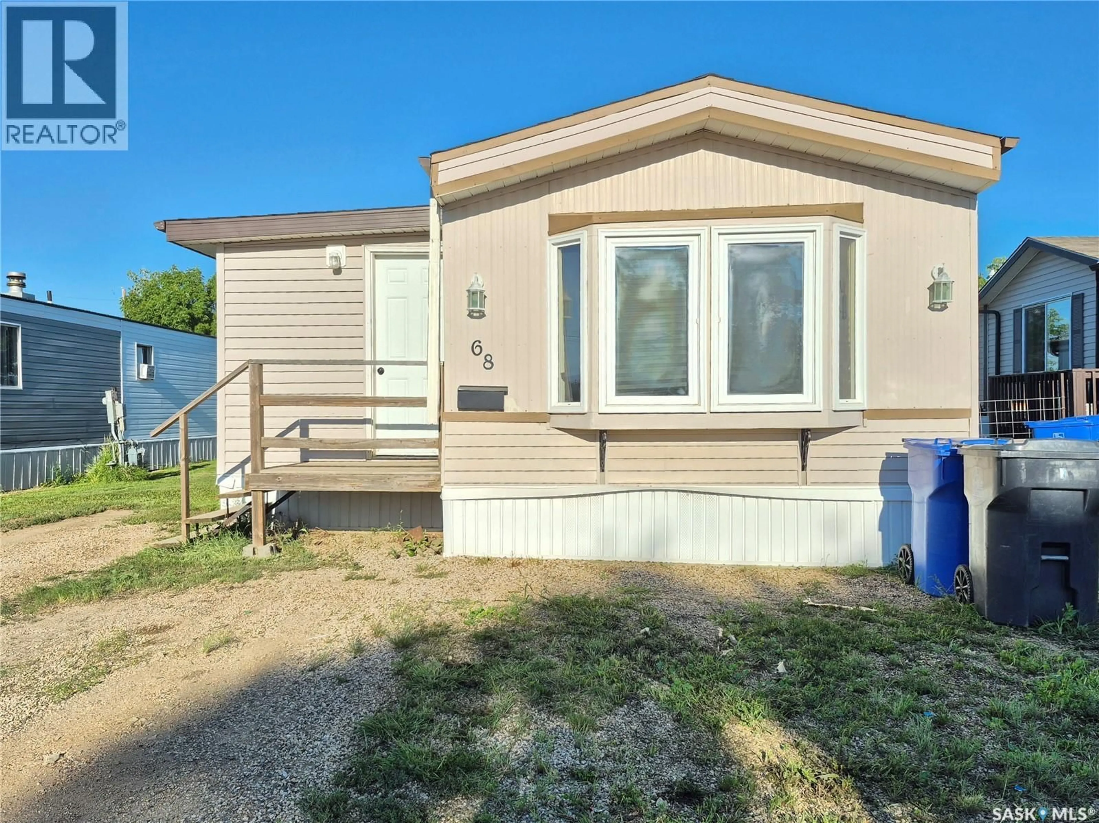 Home with vinyl exterior material, street for SW - 68 106 1ST AVENUE, Weyburn Saskatchewan S4H2J1