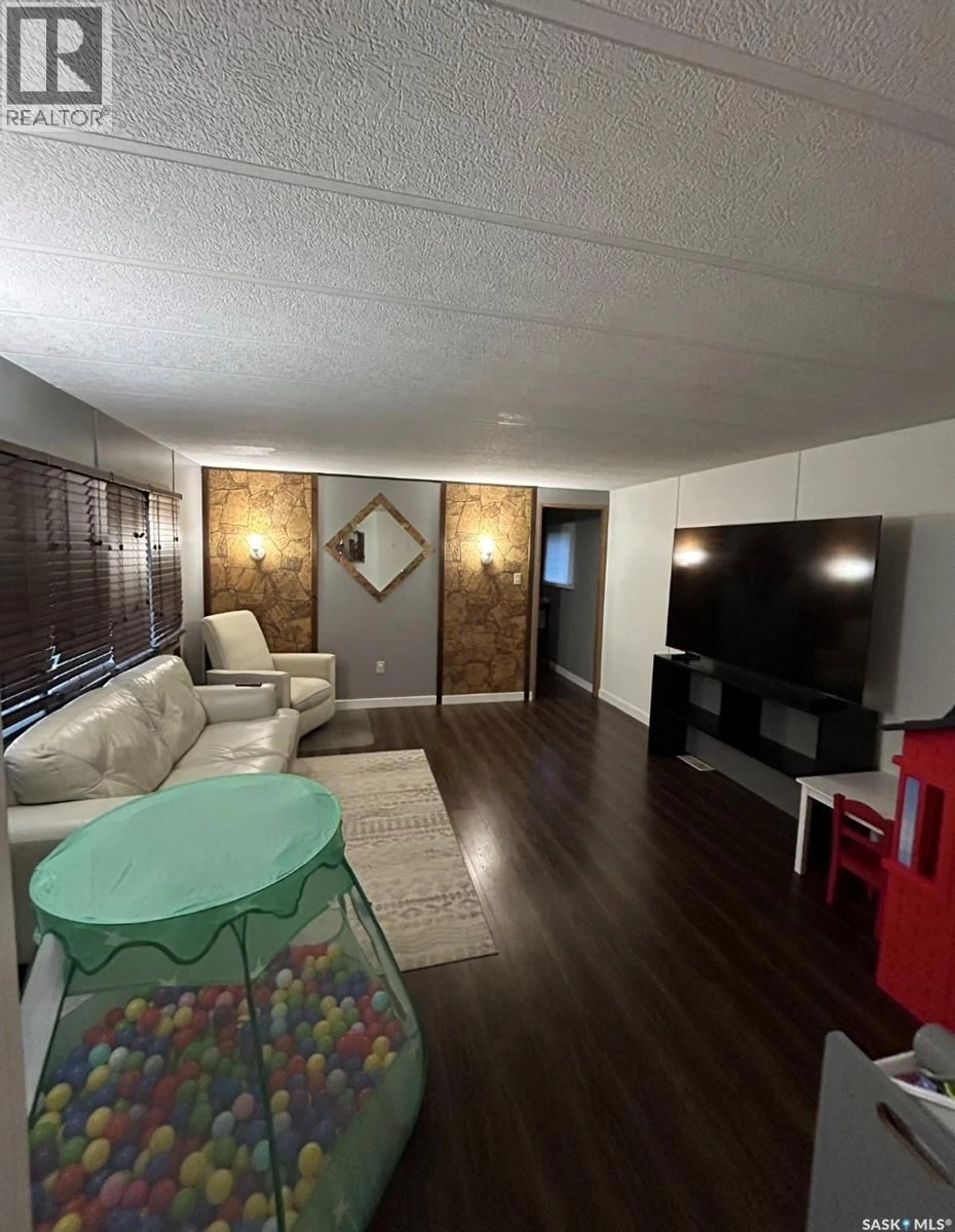 Living room with furniture, unknown for SW - 68 106 1ST AVENUE, Weyburn Saskatchewan S4H2J1