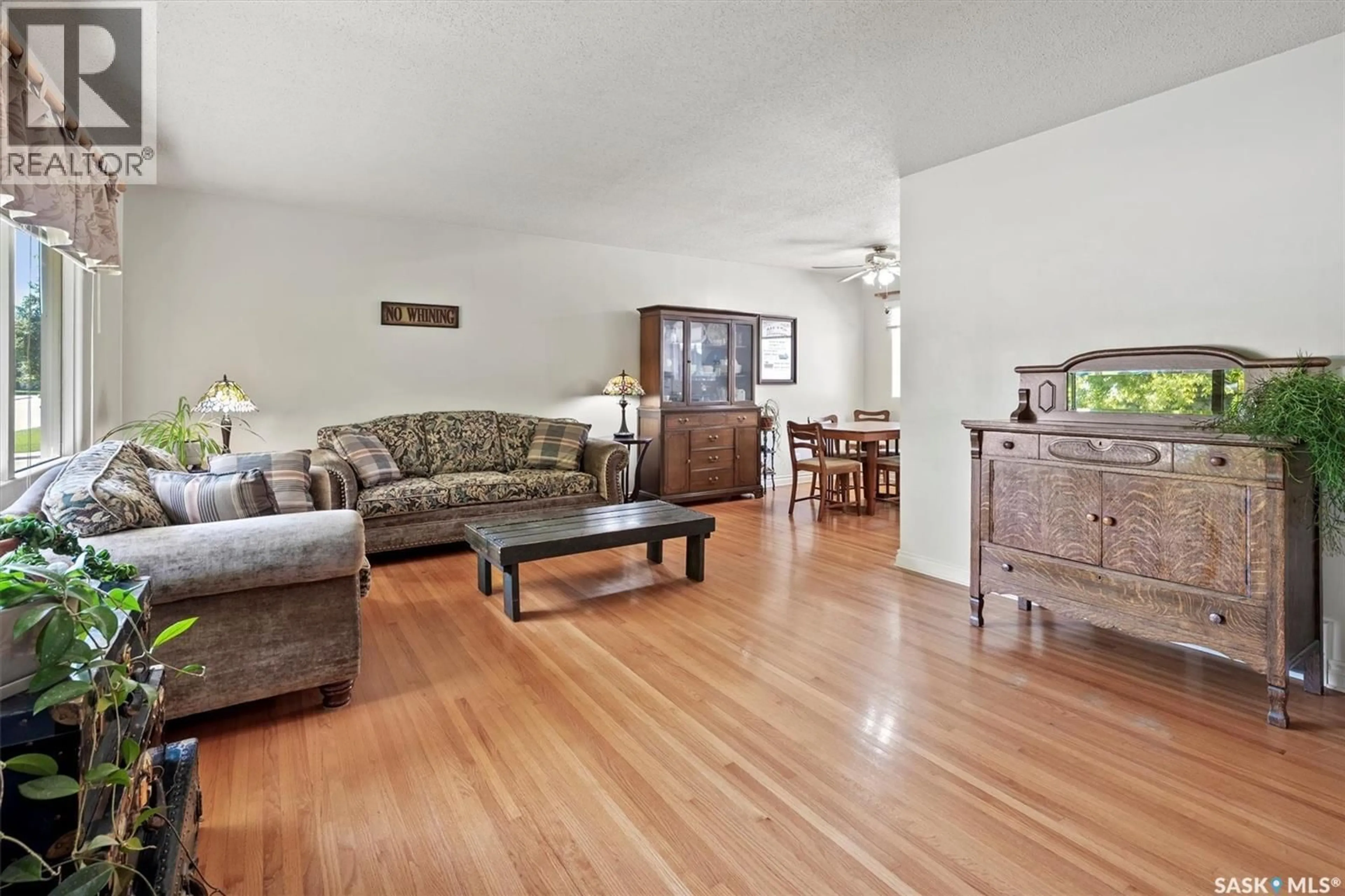 Living room with furniture, wood/laminate floor for 2431 DUFFERIN AVENUE, Saskatoon Saskatchewan S7J1C3
