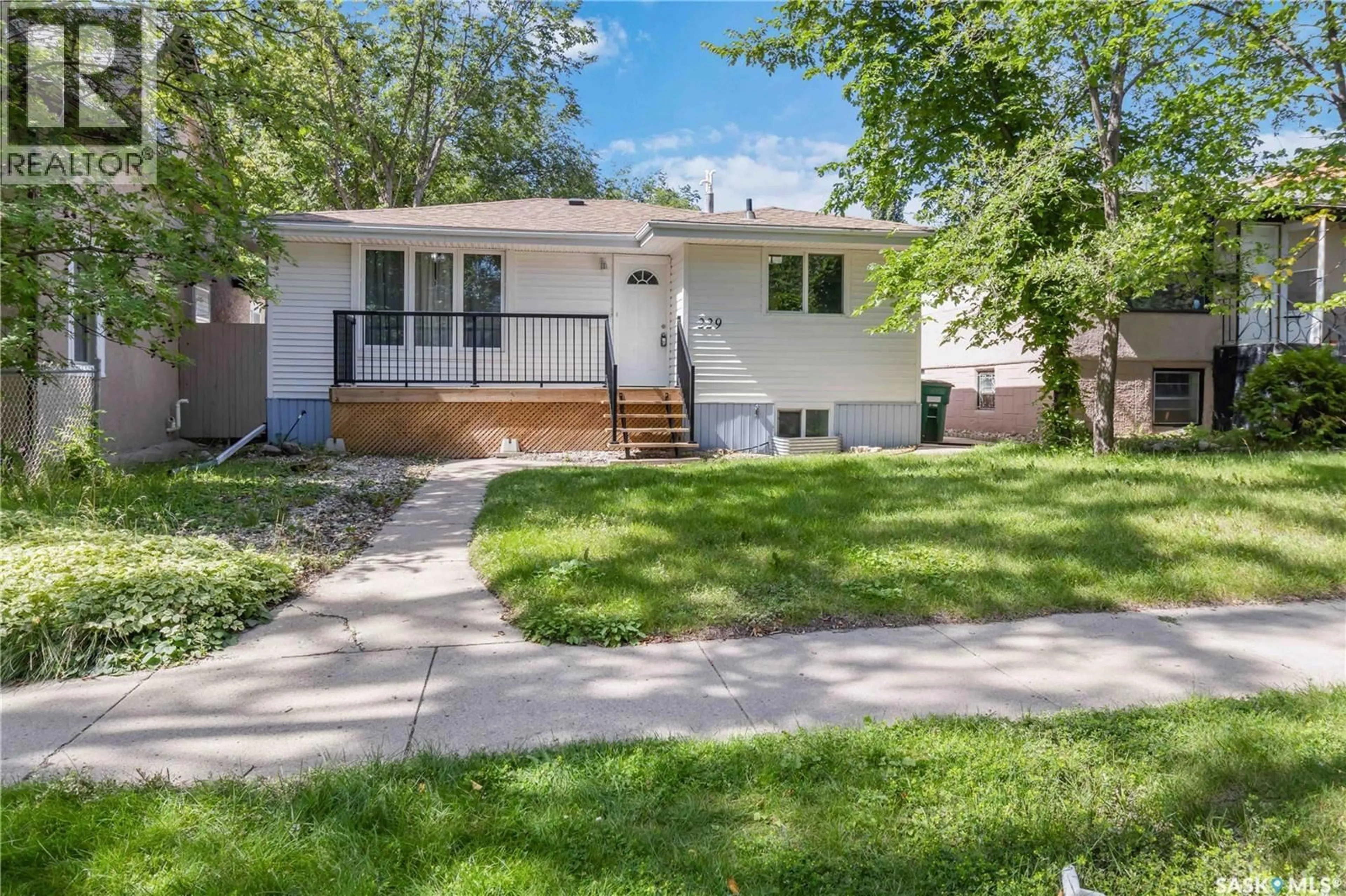 Home with vinyl exterior material, street for 229 E AVENUE, Saskatoon Saskatchewan S7L1R6