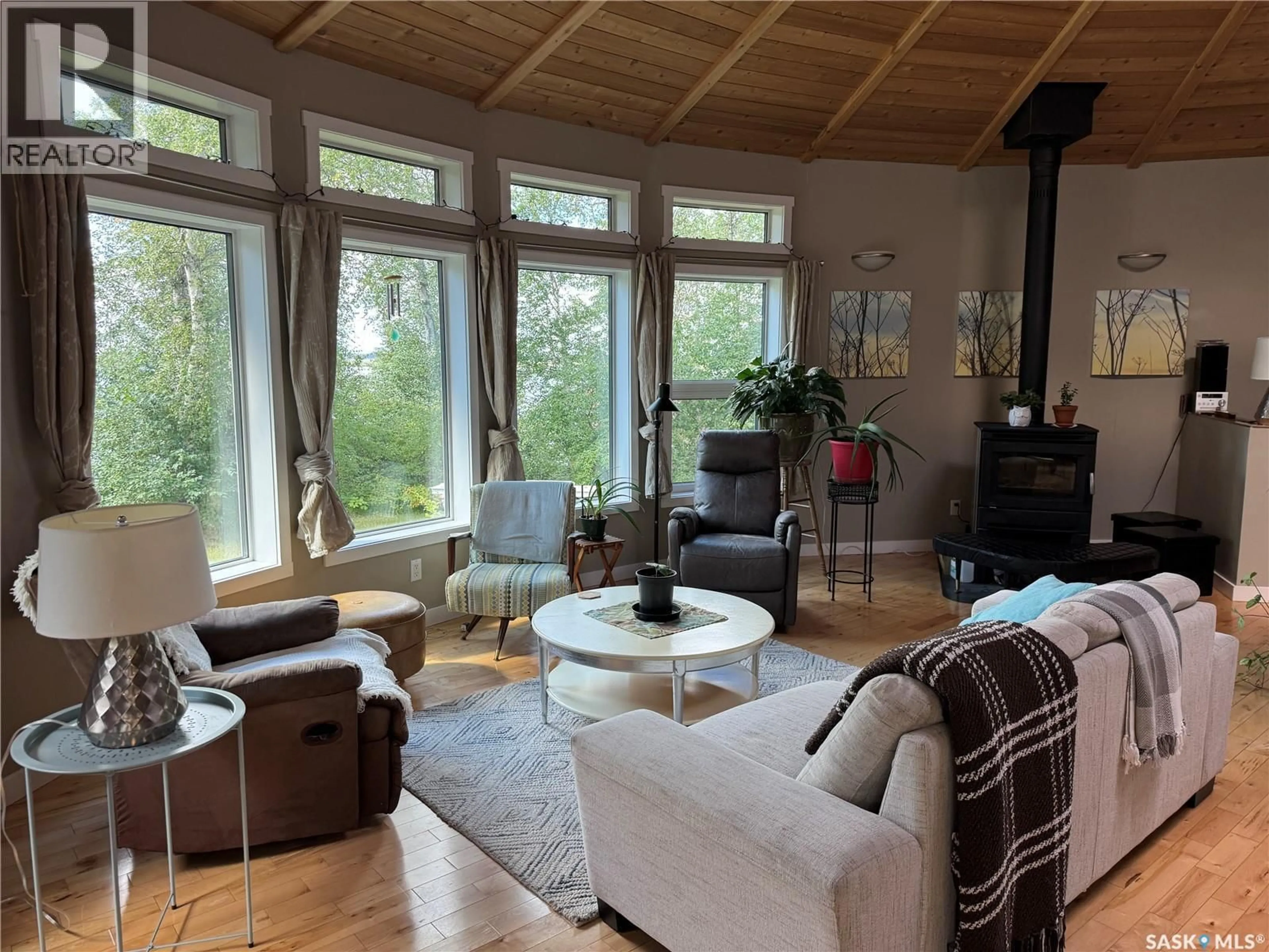 Living room with furniture, wood/laminate floor for LAKEFRONT ROUND HOUSE, Northern Admin District Saskatchewan S0J1L0