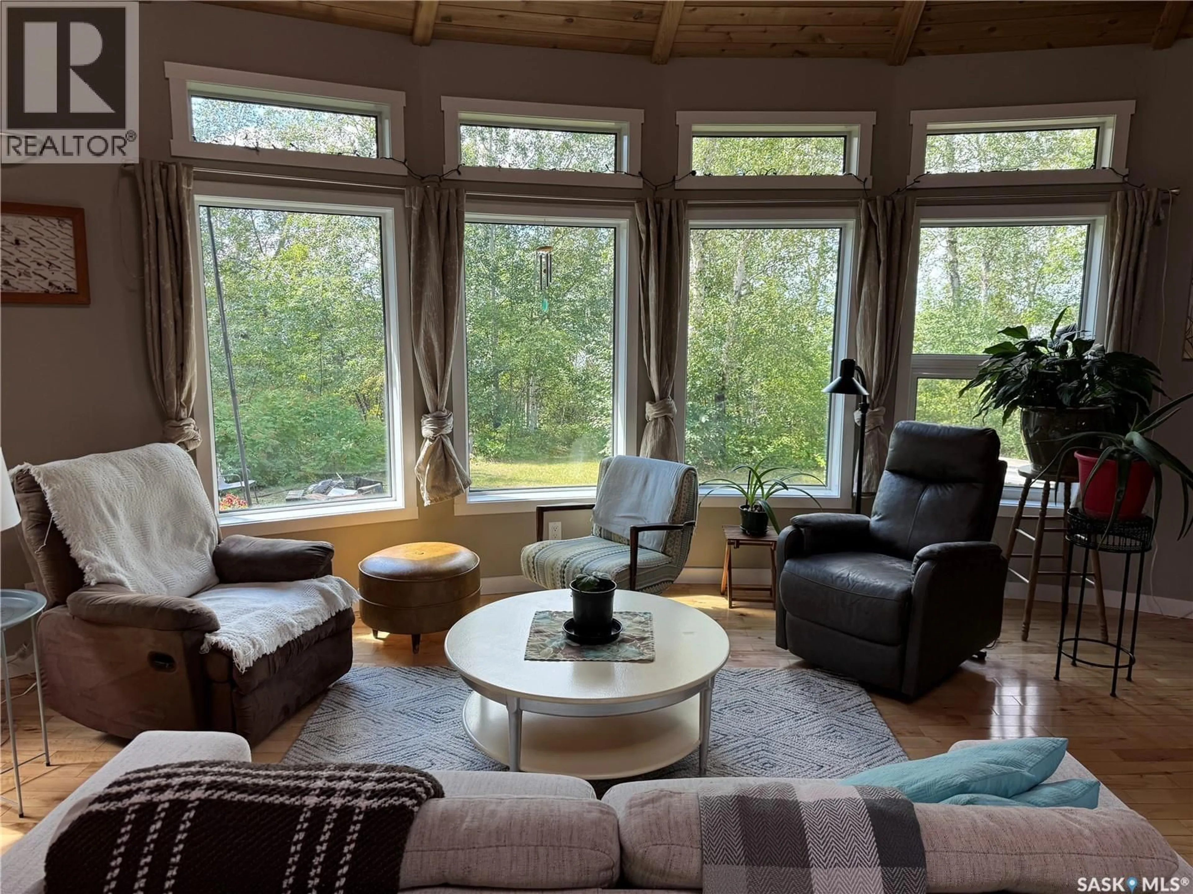 Living room with furniture, wood/laminate floor for LAKEFRONT ROUND HOUSE, Northern Admin District Saskatchewan S0J1L0