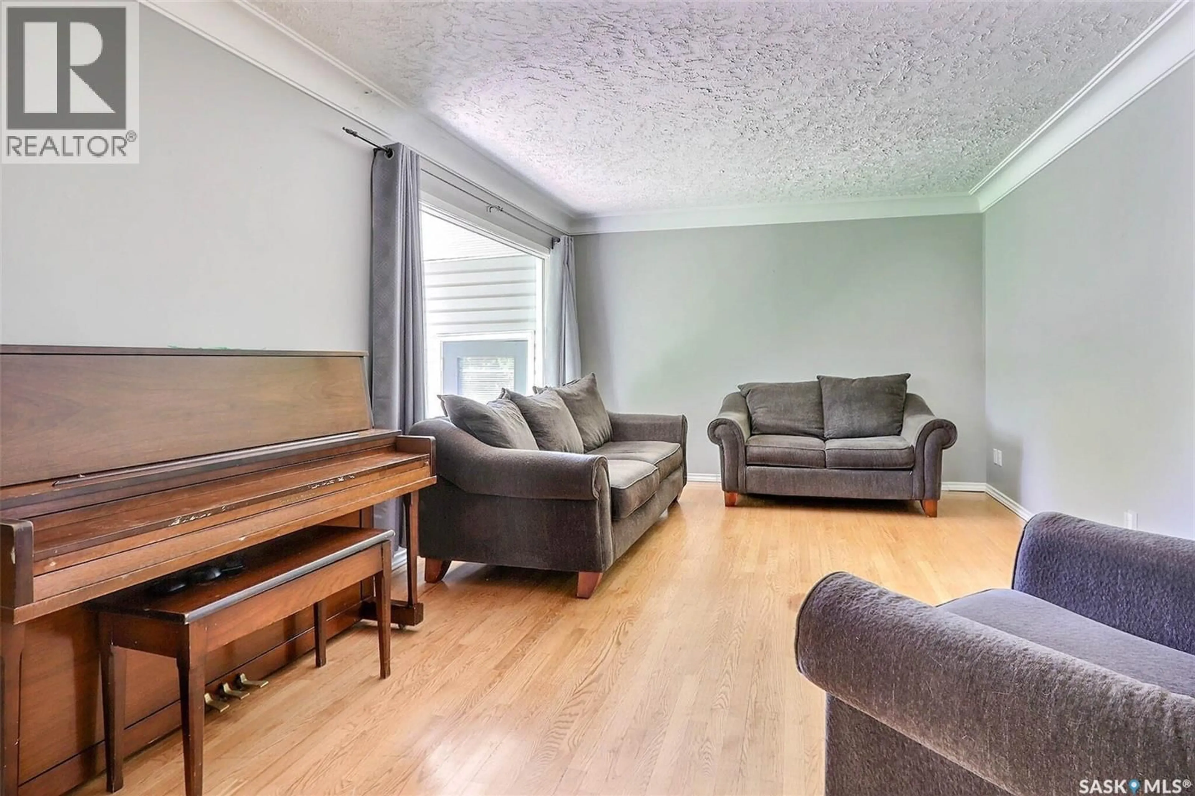 Living room with furniture, wood/laminate floor for 324 19TH STREET, Prince Albert Saskatchewan S6V4C7