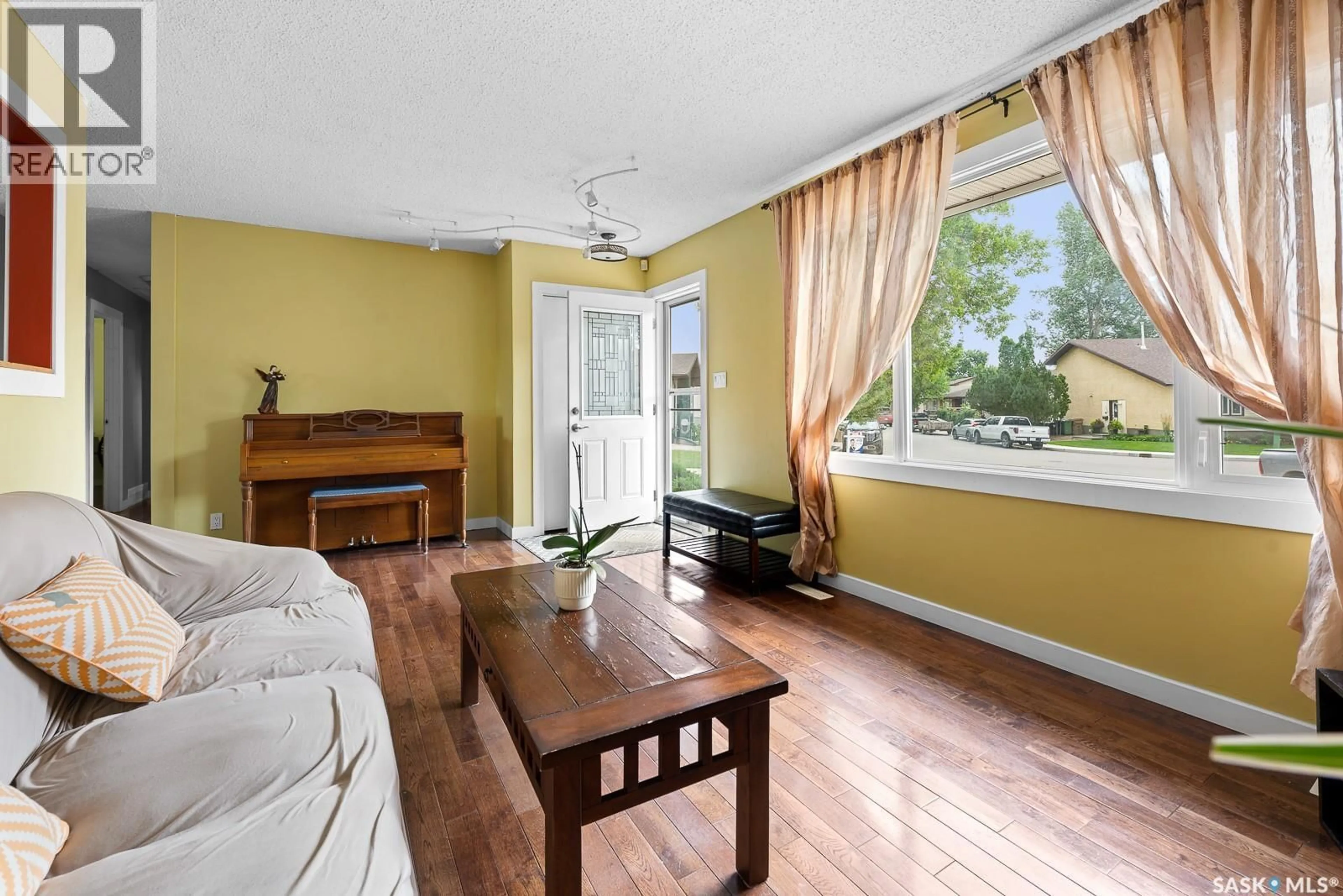 Living room with furniture, wood/laminate floor for 762 BARD CRESCENT, Regina Saskatchewan S4X2K5