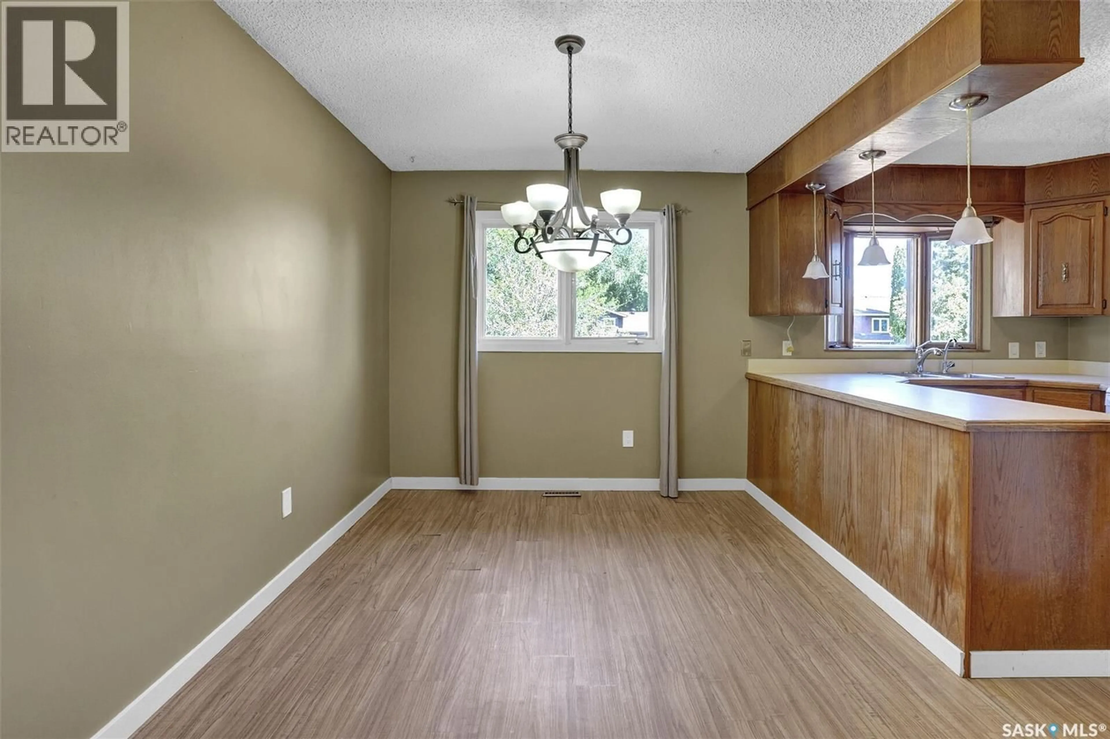 Open concept kitchen, wood/laminate floor for 71 RENDEK CRESCENT, Regina Saskatchewan S4X2V2