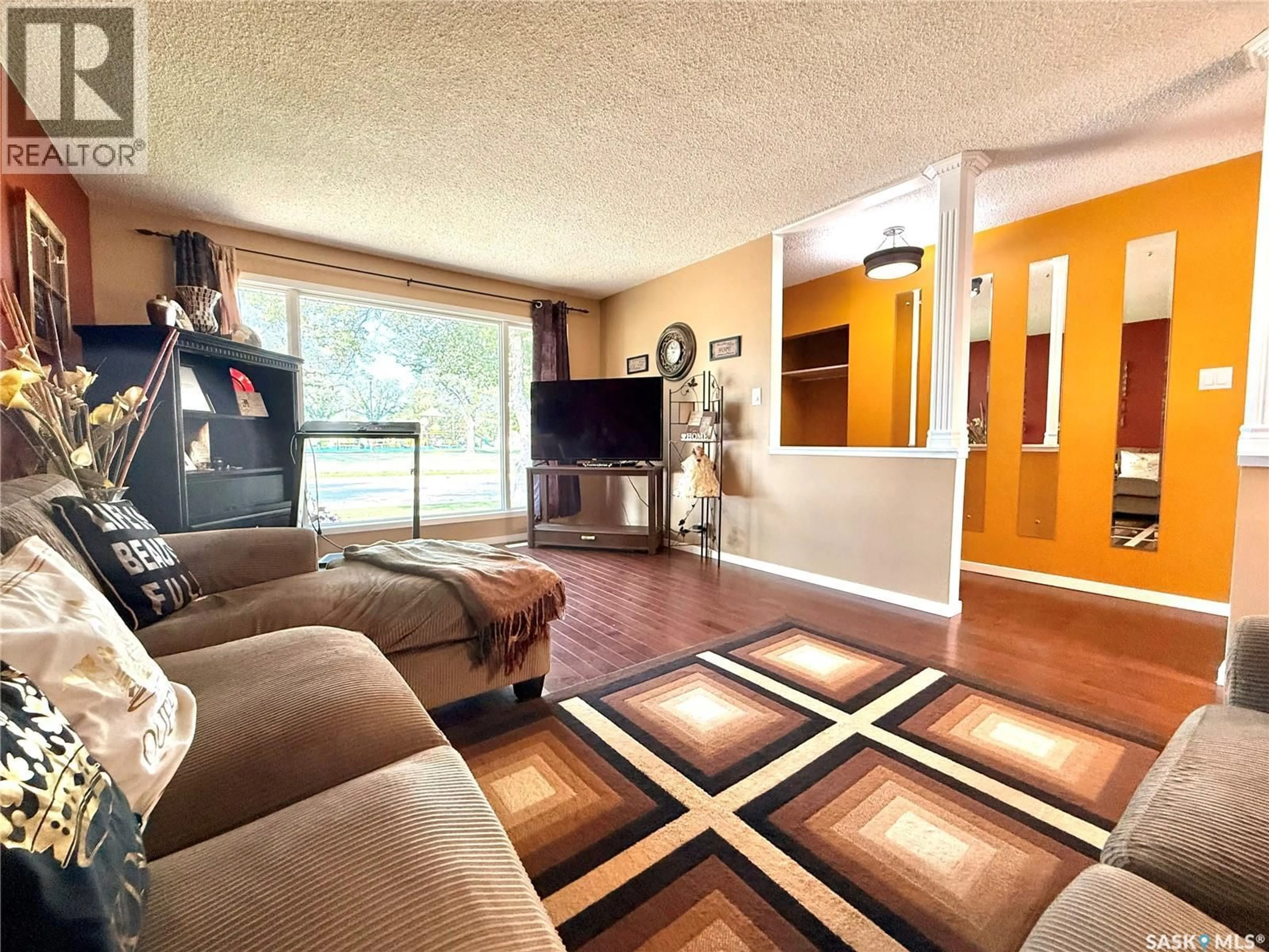 Living room with furniture, wood/laminate floor for 417 CENTRAL AVENUE, Swift Current Saskatchewan S9H3G5