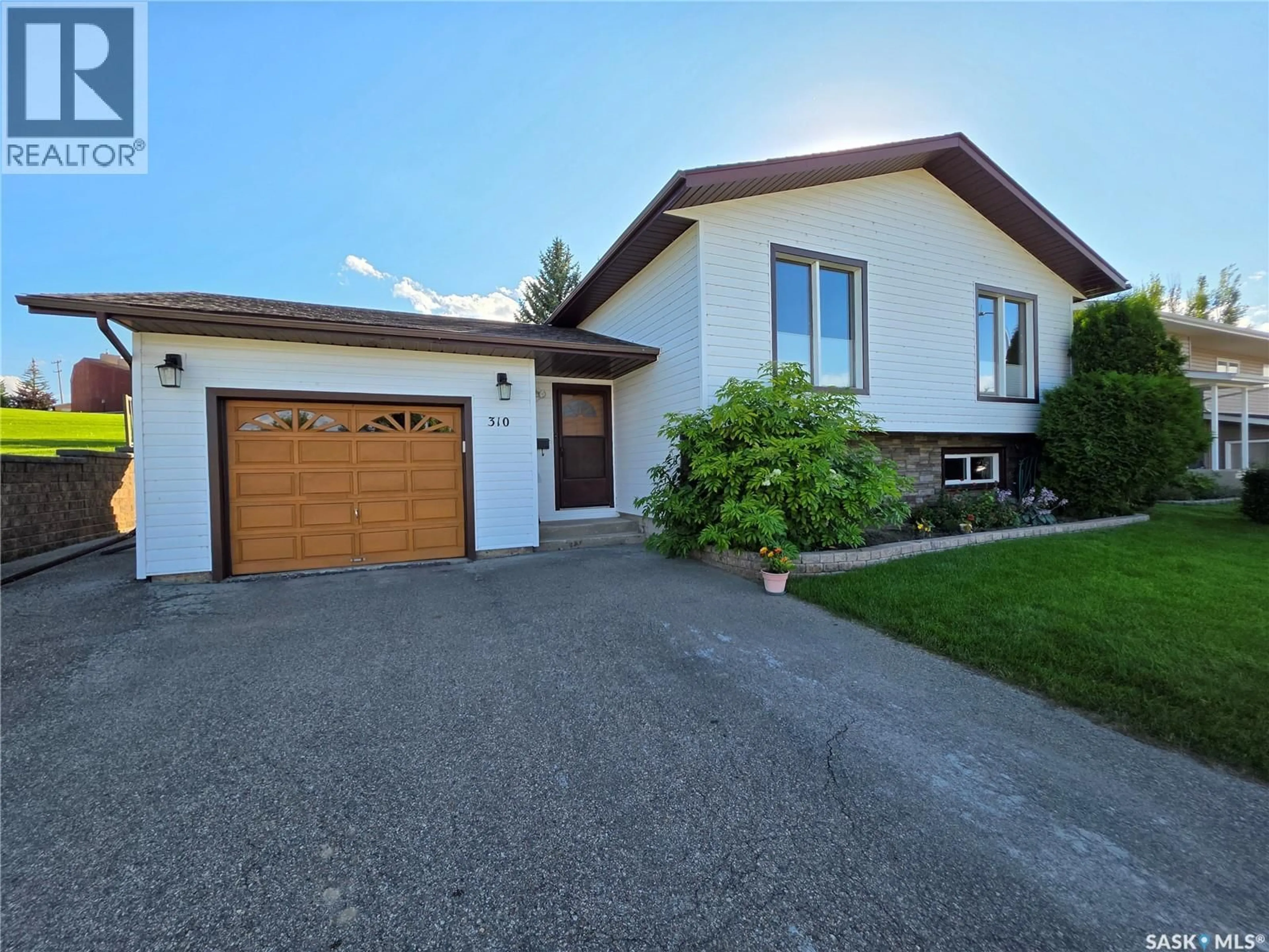 Home with vinyl exterior material, street for 310 ASPEN DRIVE, Swift Current Saskatchewan S9H4T1