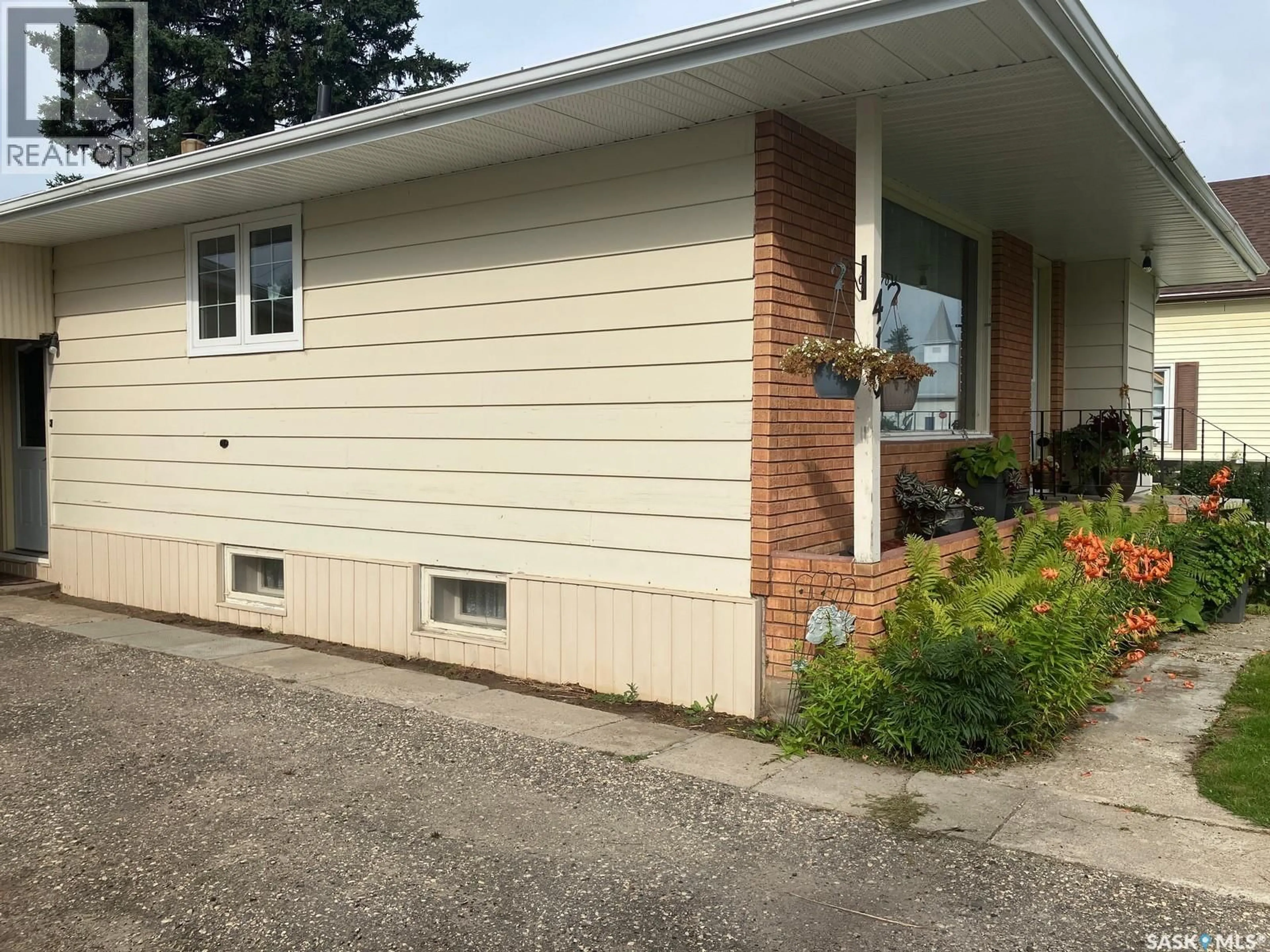 Home with vinyl exterior material, street for 410 1ST STREET, Nipawin Saskatchewan S0E1E0