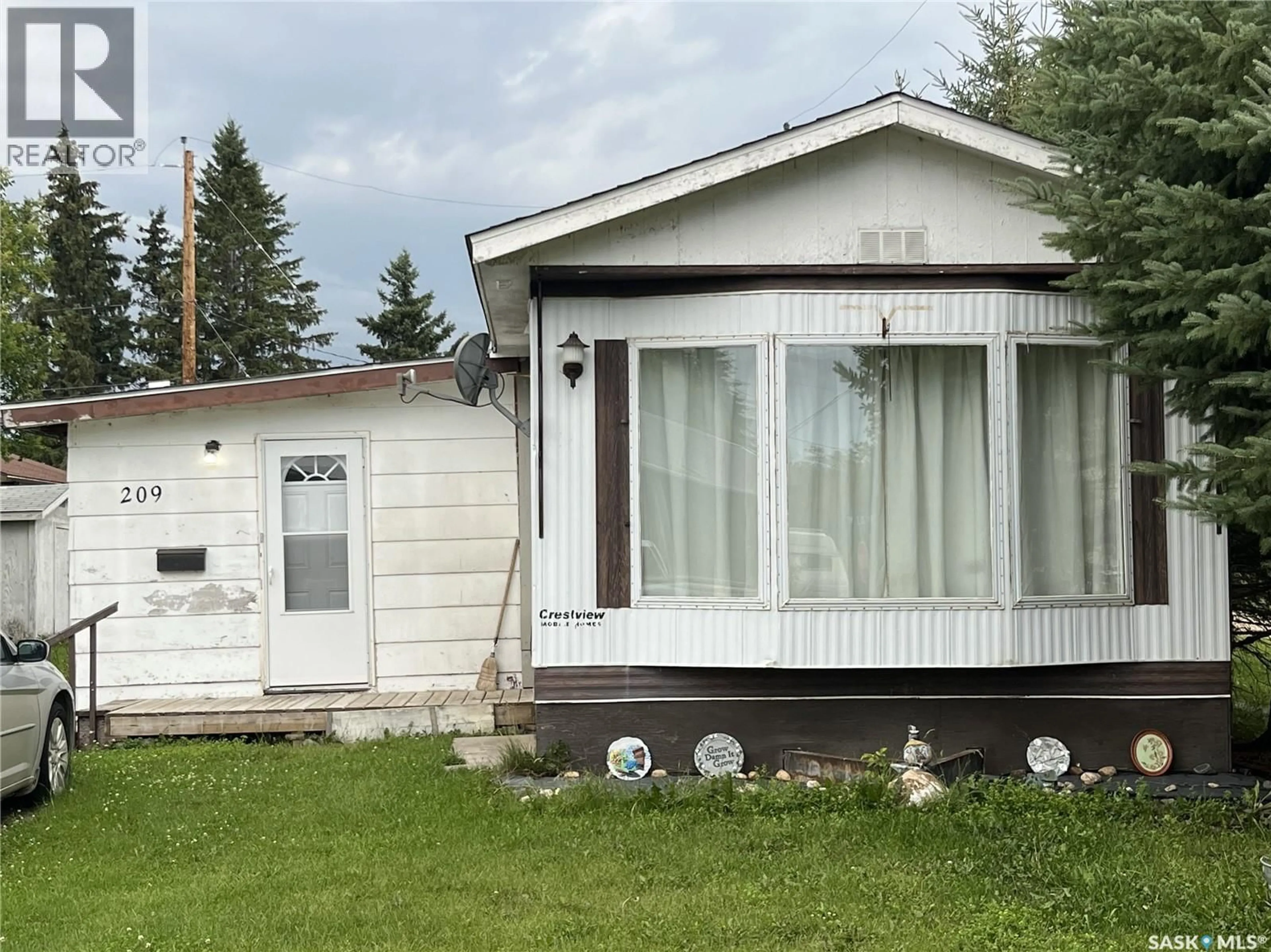 Home with vinyl exterior material, street for 209 1ST STREET, Meath Park Saskatchewan S0J1T0