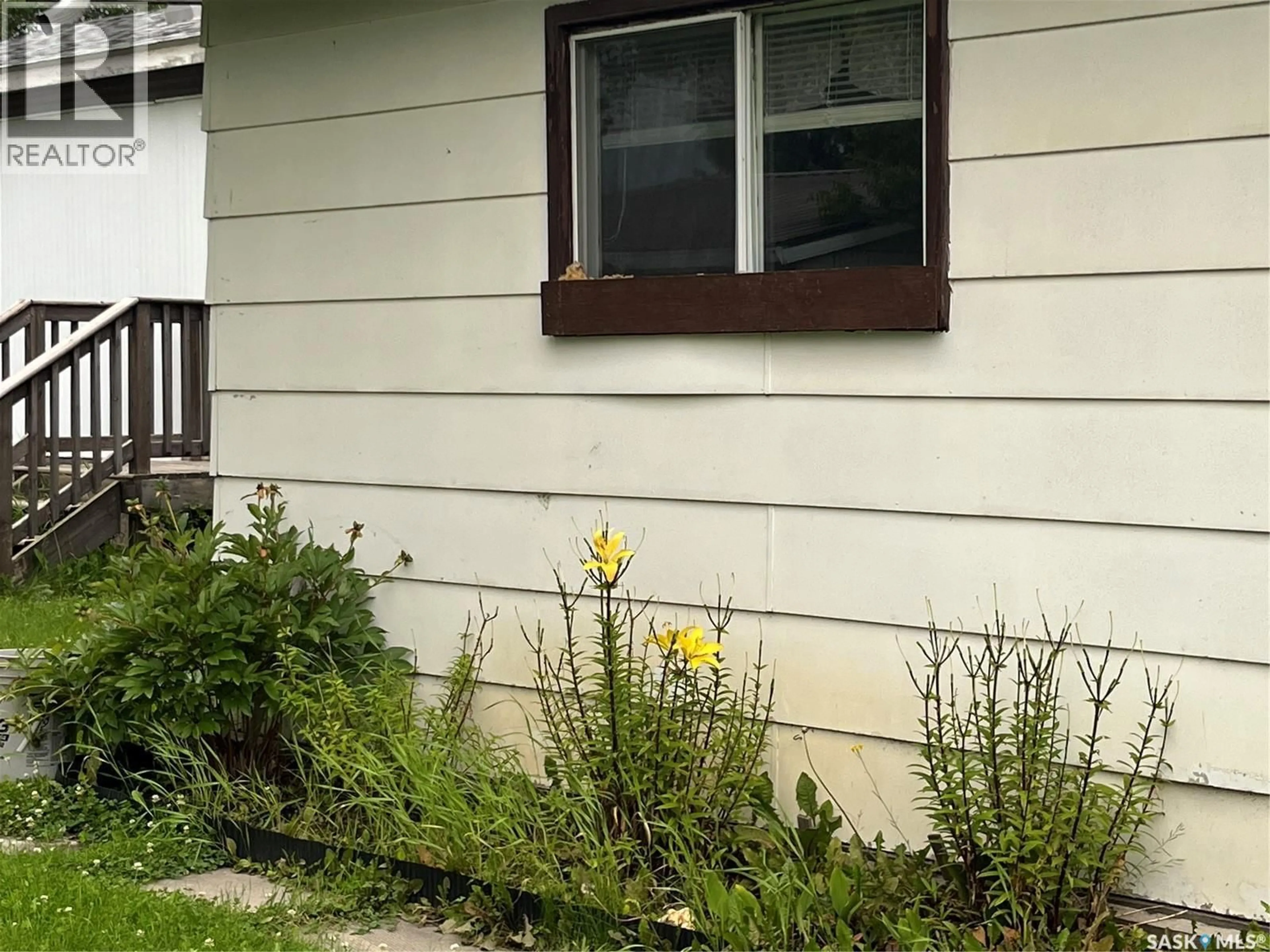 Home with vinyl exterior material, street for 209 1ST STREET, Meath Park Saskatchewan S0J1T0
