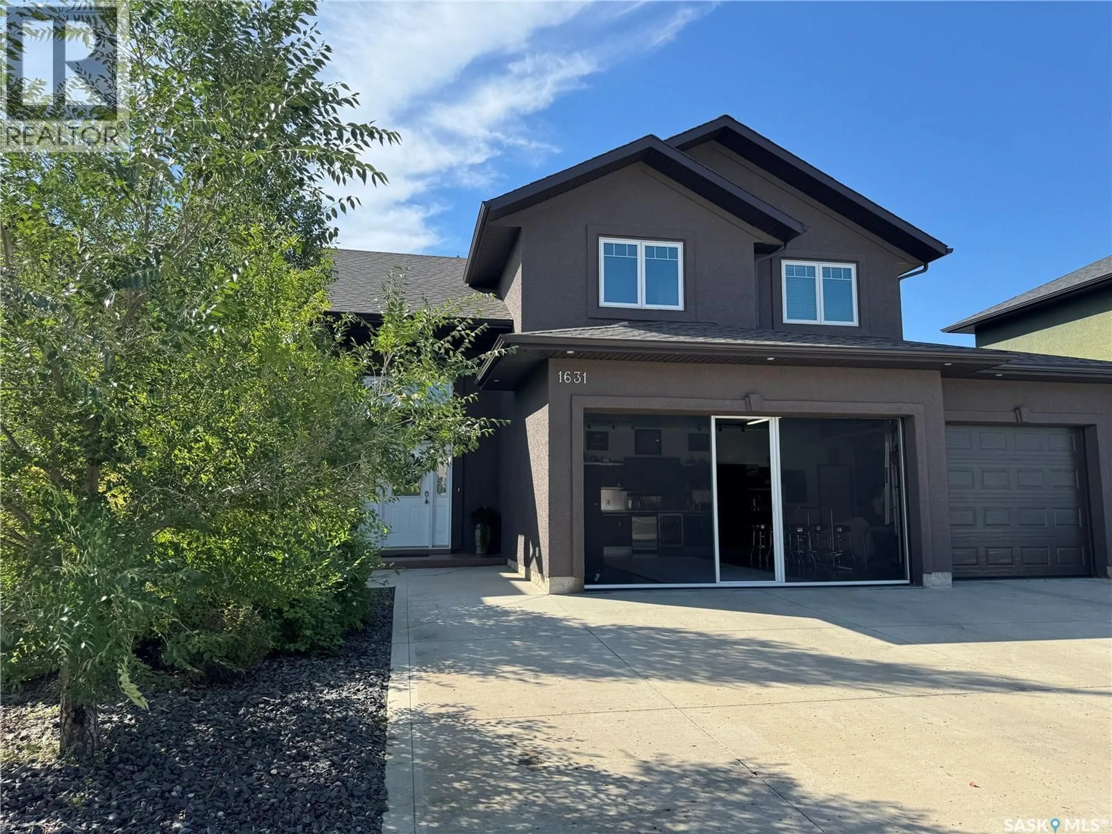 Home with vinyl exterior material, street for 1631 STENSRUD ROAD, Saskatoon Saskatchewan S7W0C4