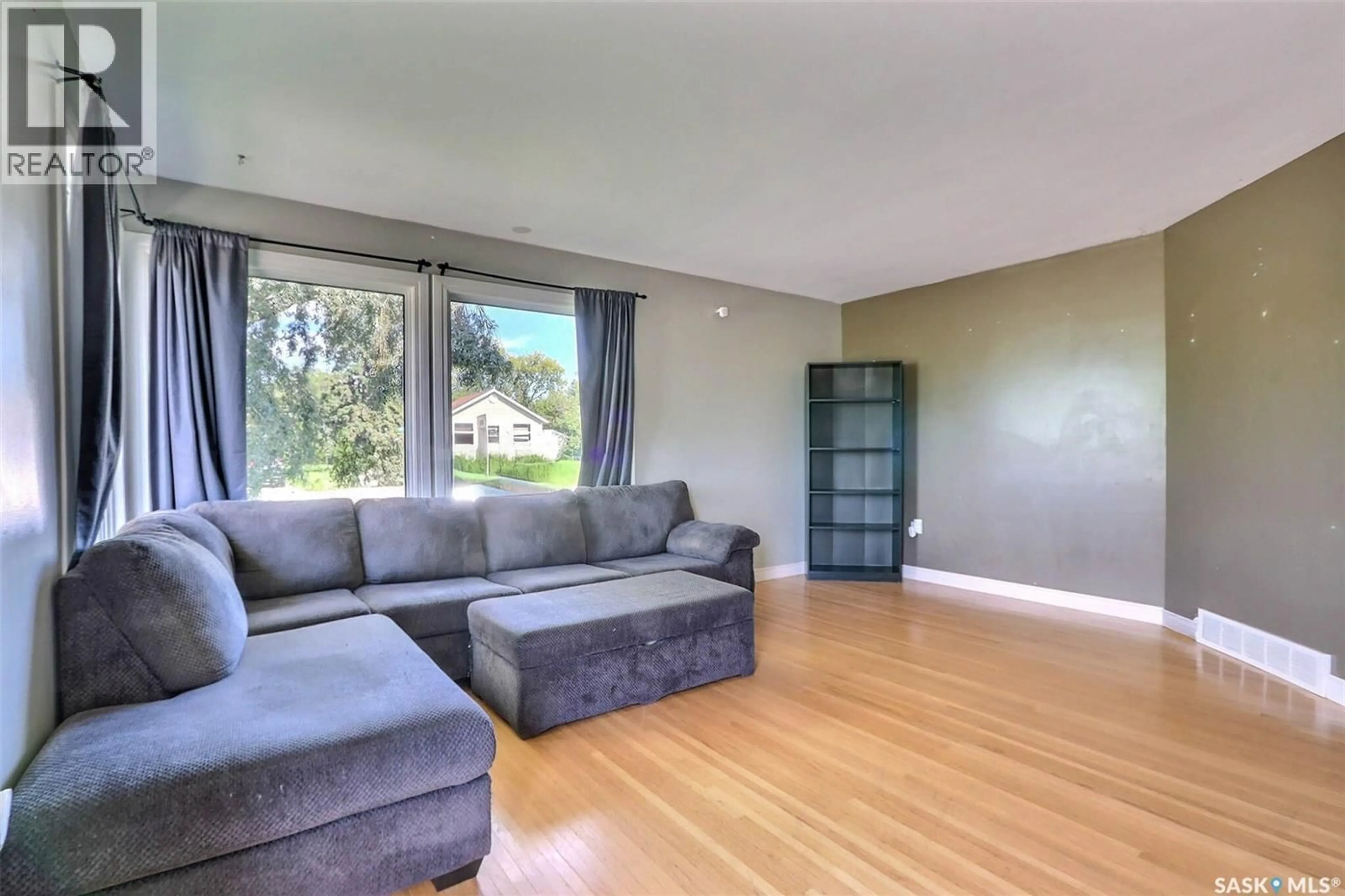 Living room with furniture, wood/laminate floor for 429 23RD STREET, Prince Albert Saskatchewan S6V4M2