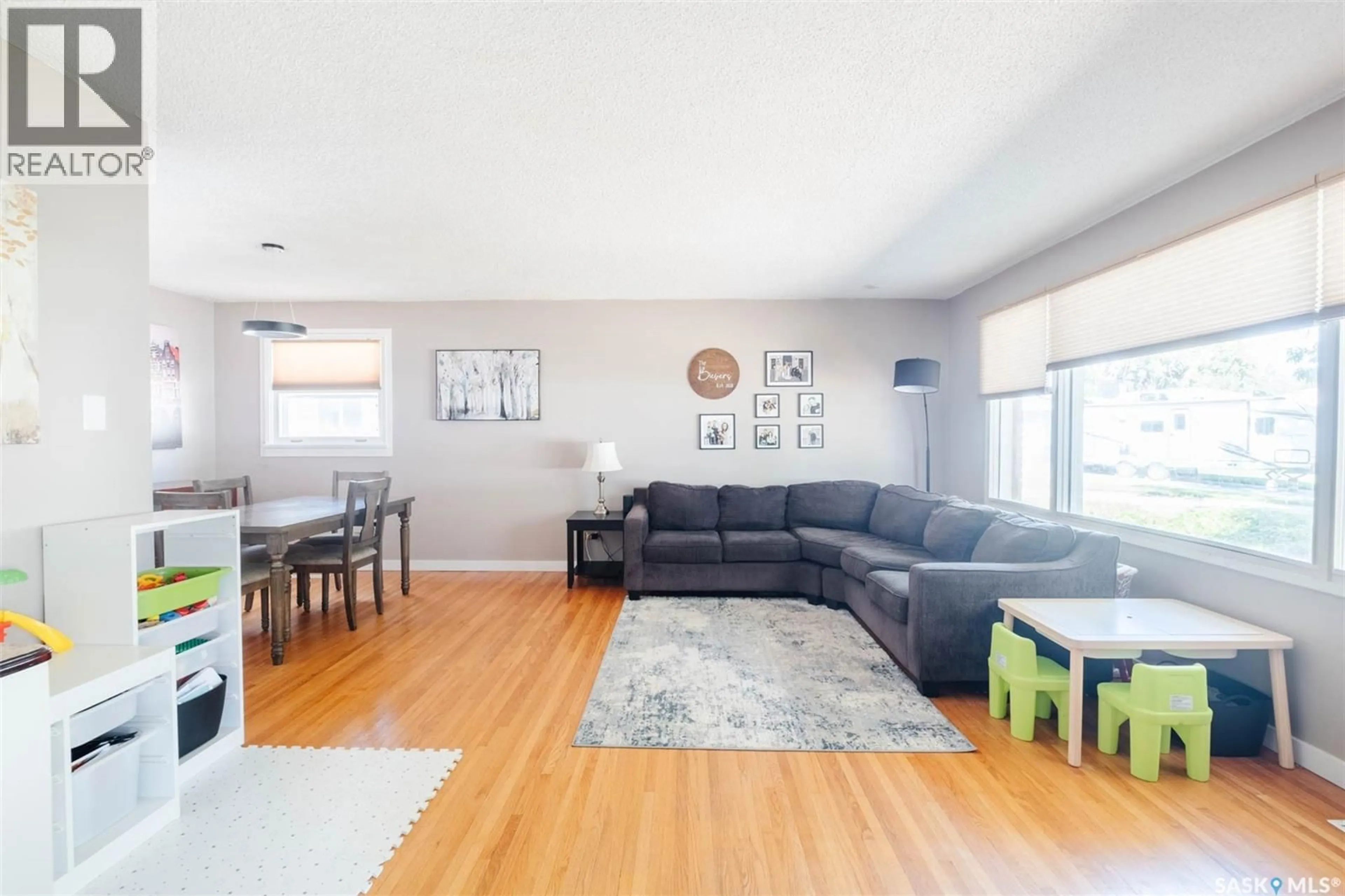 Living room with furniture, wood/laminate floor for 26 LAMONT CRESCENT, Regina Saskatchewan S4S4A4