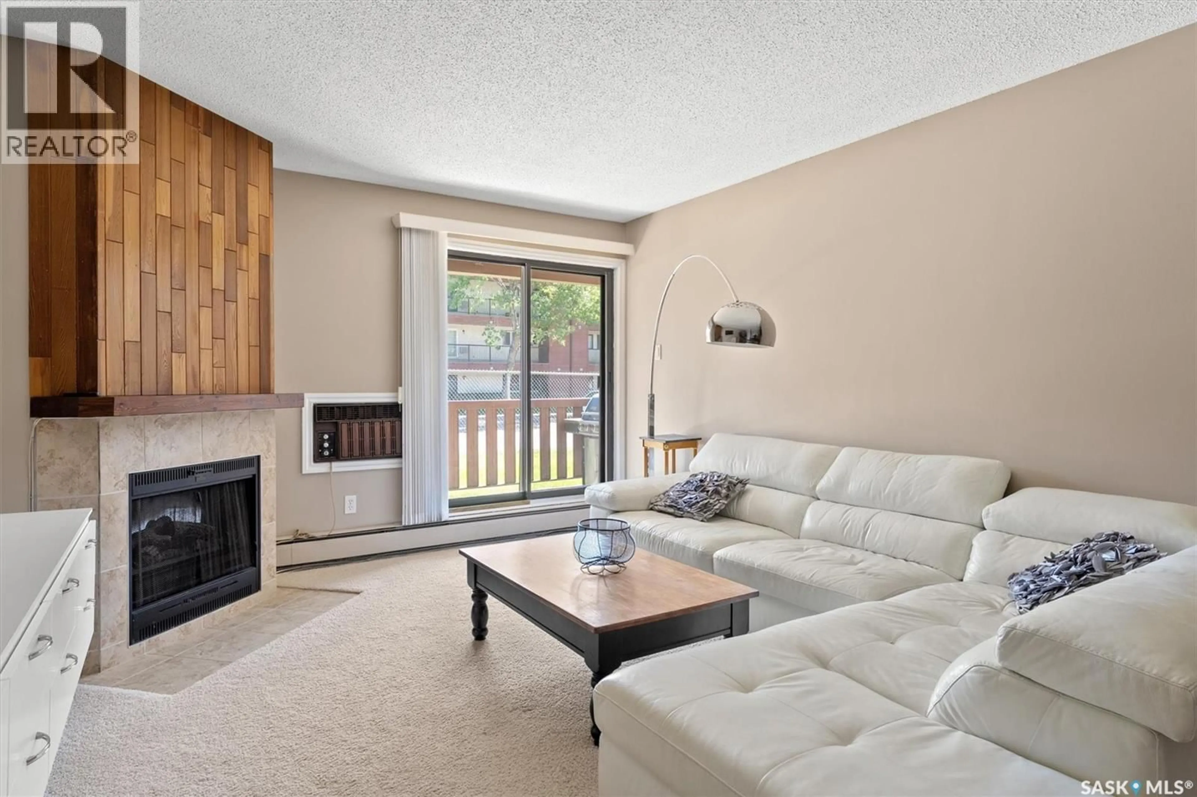 Living room with furniture, wood/laminate floor for 102c - 1121 MCKERCHER DRIVE, Saskatoon Saskatchewan S7H5B8