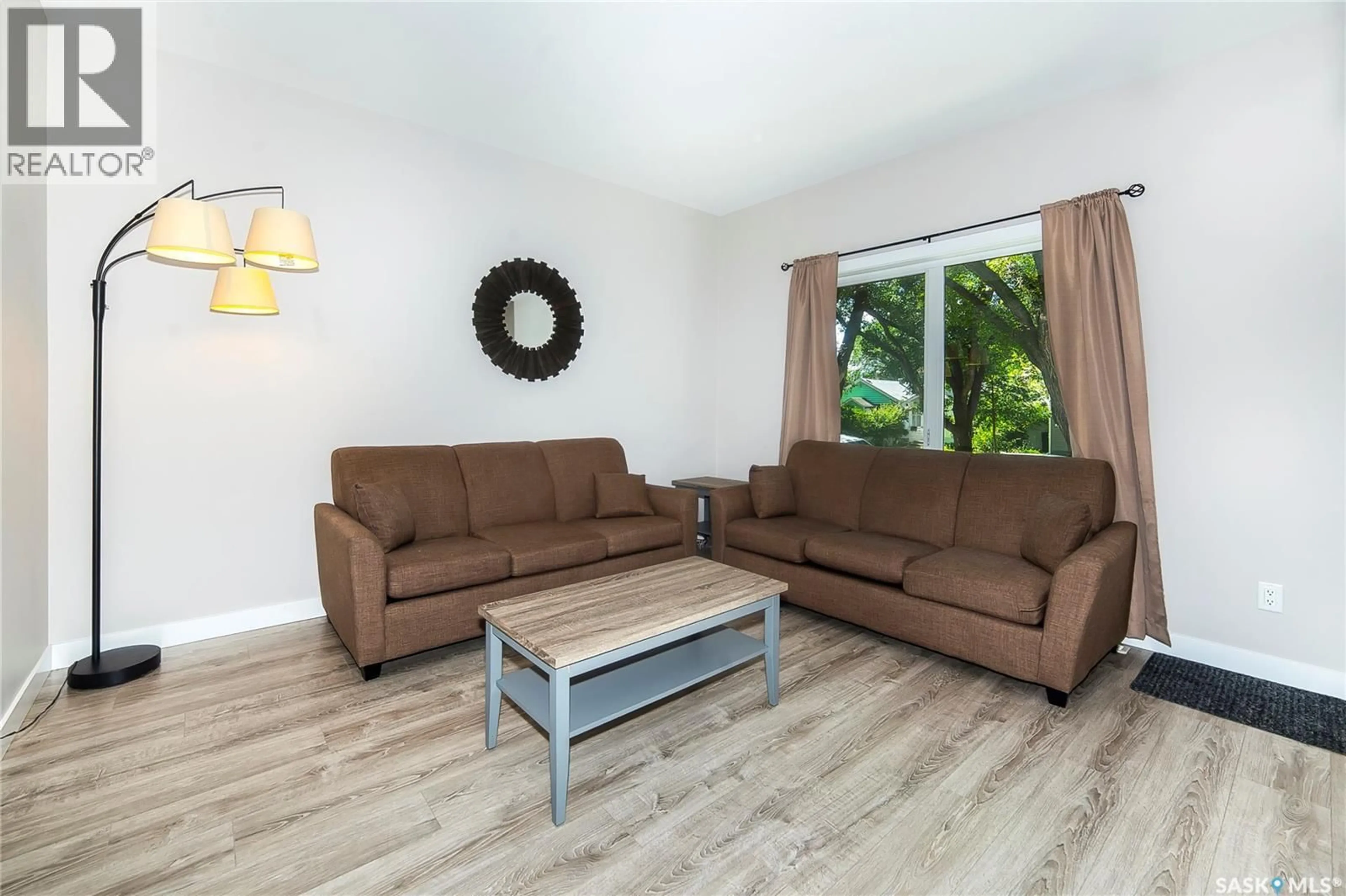 Living room with furniture, wood/laminate floor for 1320 B AVENUE, Saskatoon Saskatchewan S7L1G5