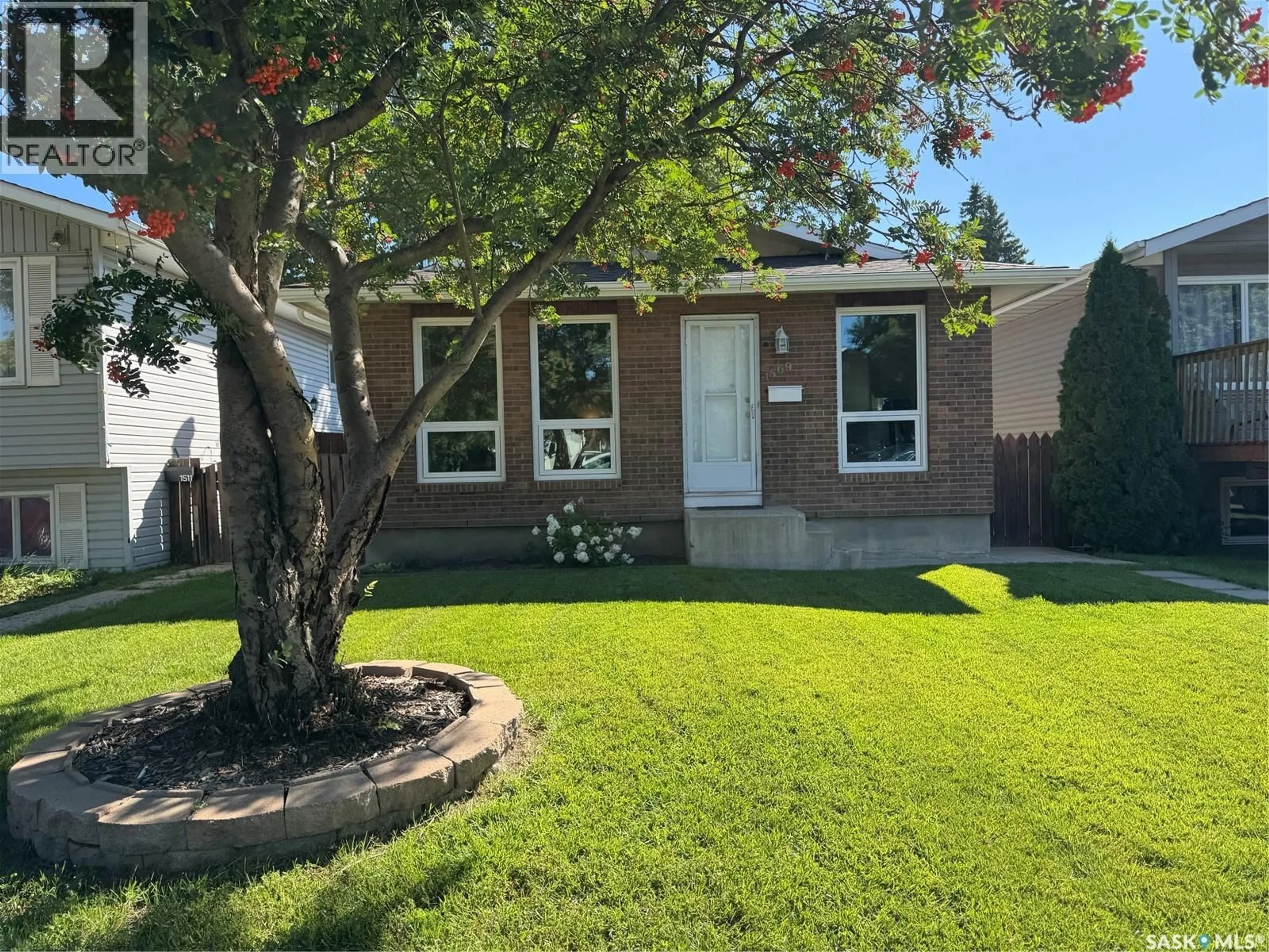 Home with vinyl exterior material, street for 1509 LAURA AVENUE, Saskatoon Saskatchewan S7N2R8
