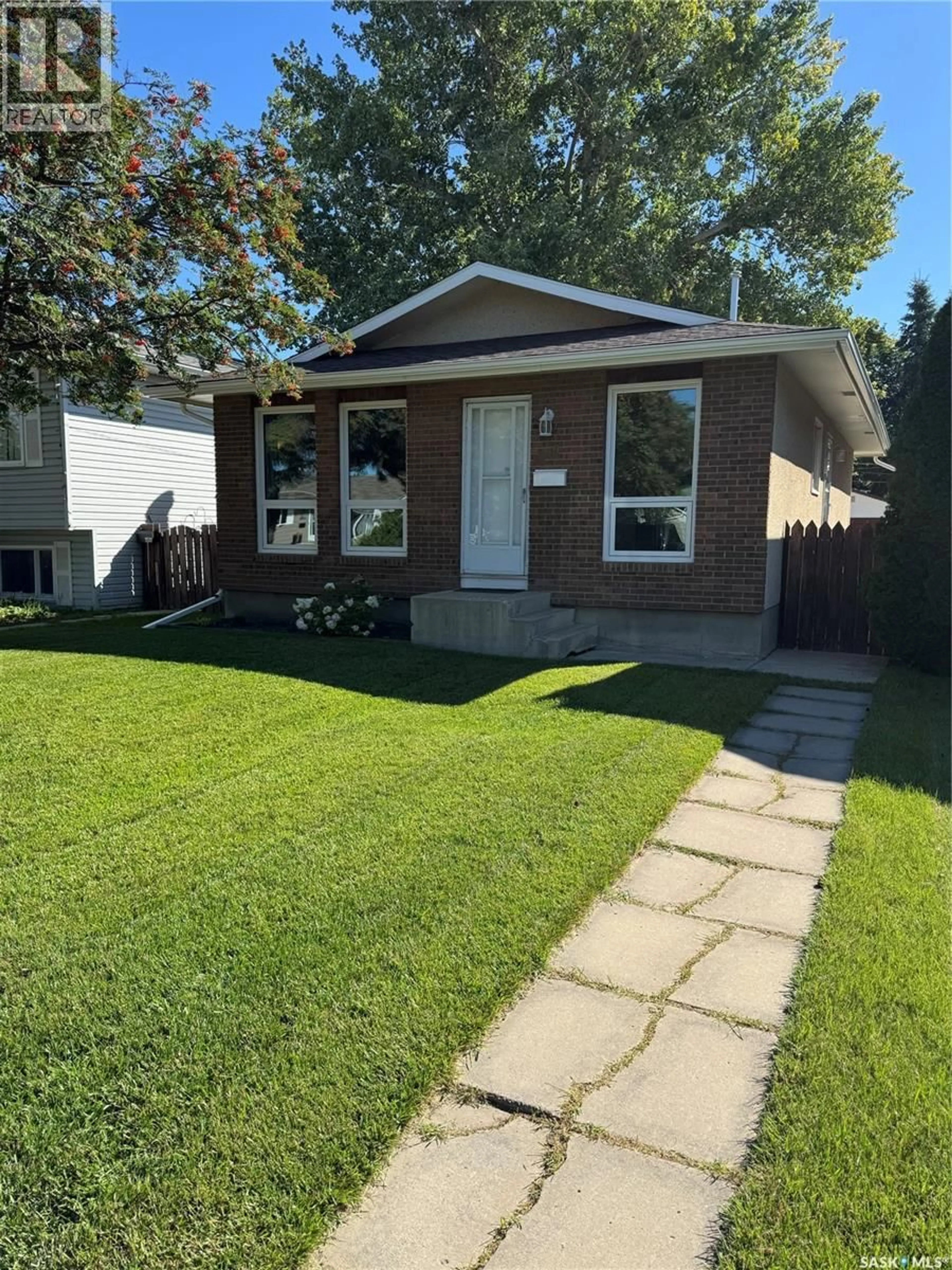 Home with vinyl exterior material, street for 1509 LAURA AVENUE, Saskatoon Saskatchewan S7N2R8