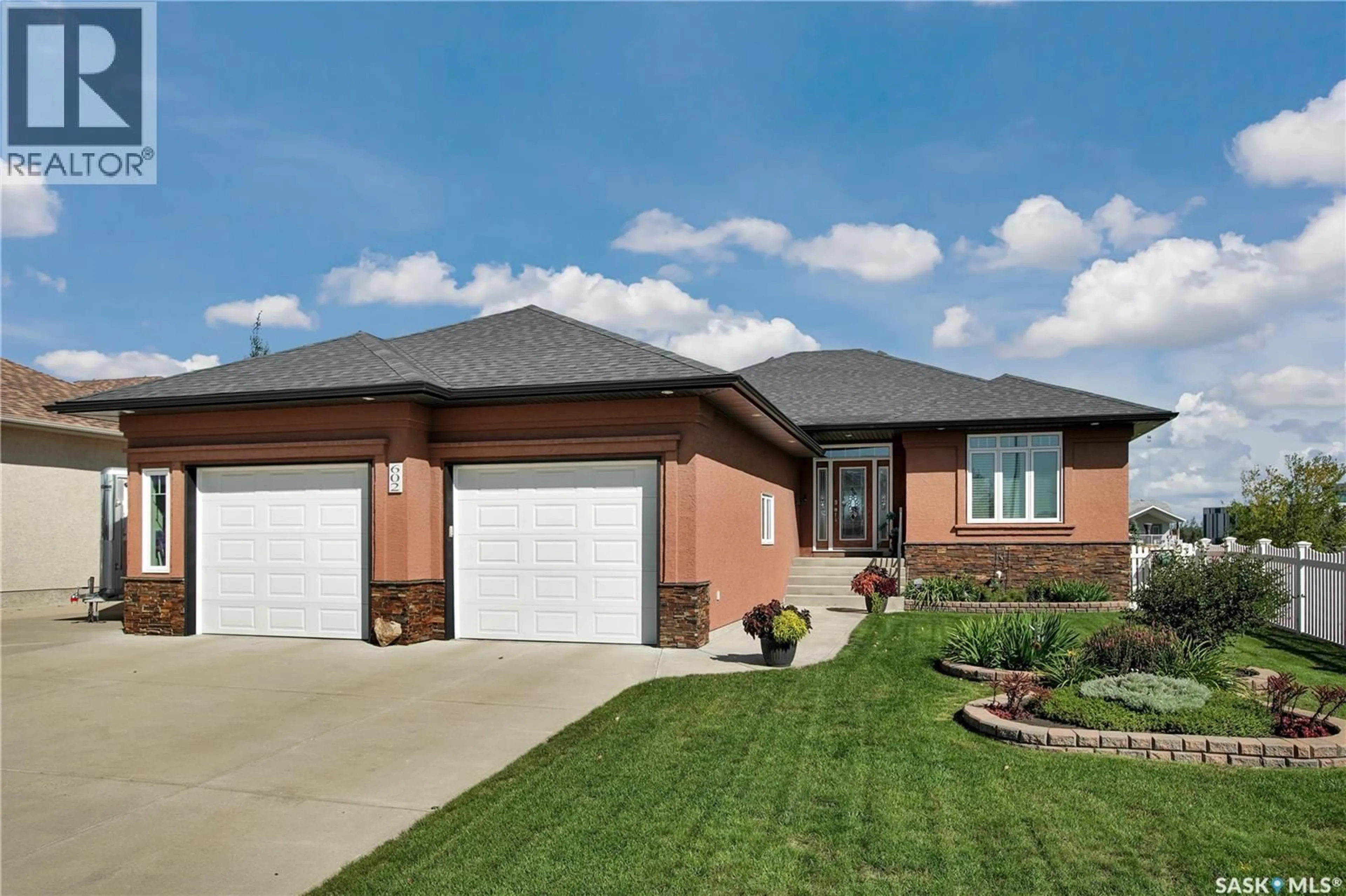 Home with brick exterior material, street for 602 THIESSEN STREET, Warman Saskatchewan S0K4S2