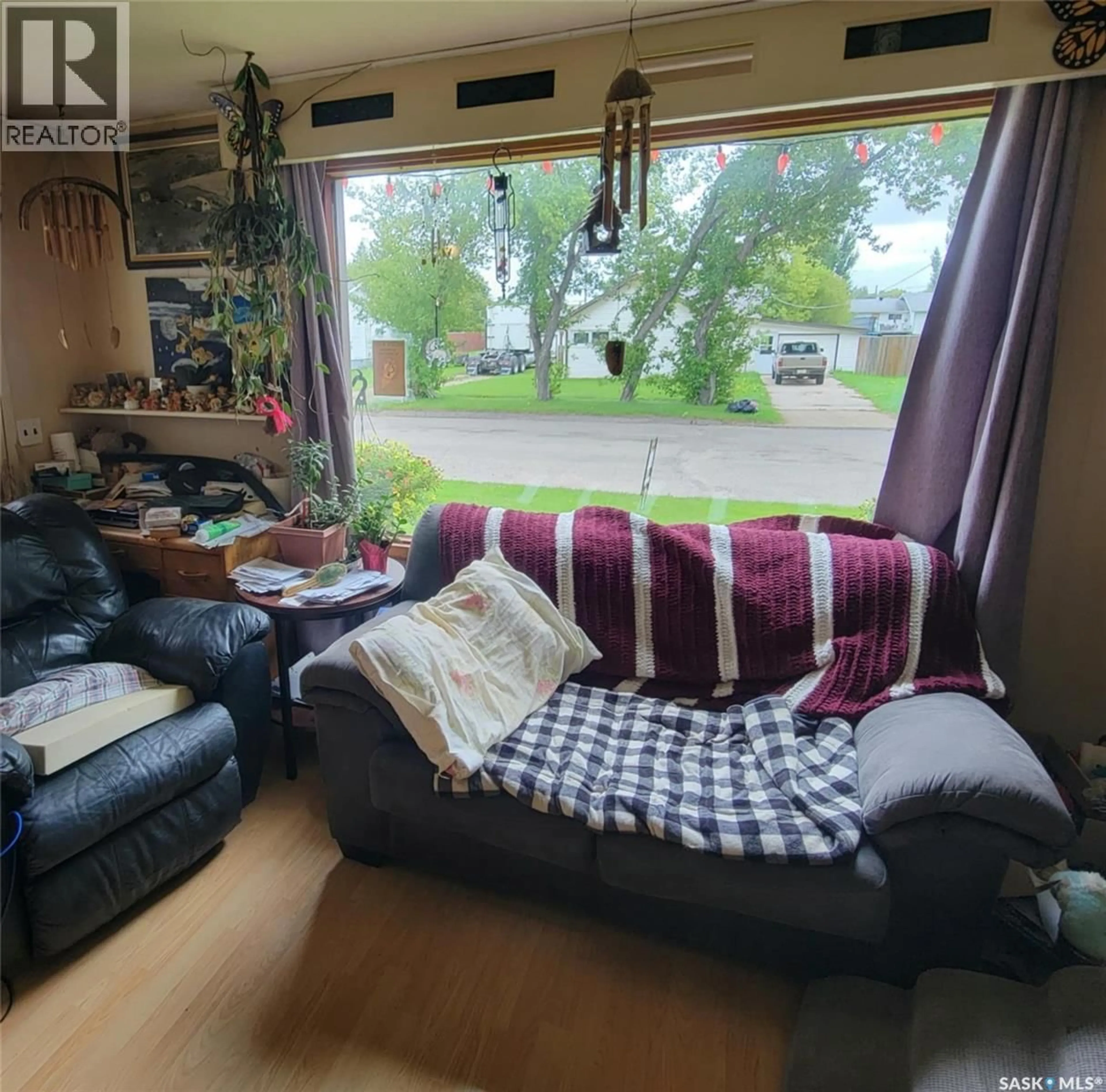 Living room with furniture, wood/laminate floor for 231 THIRD STREET, Preeceville Saskatchewan S0A3B0