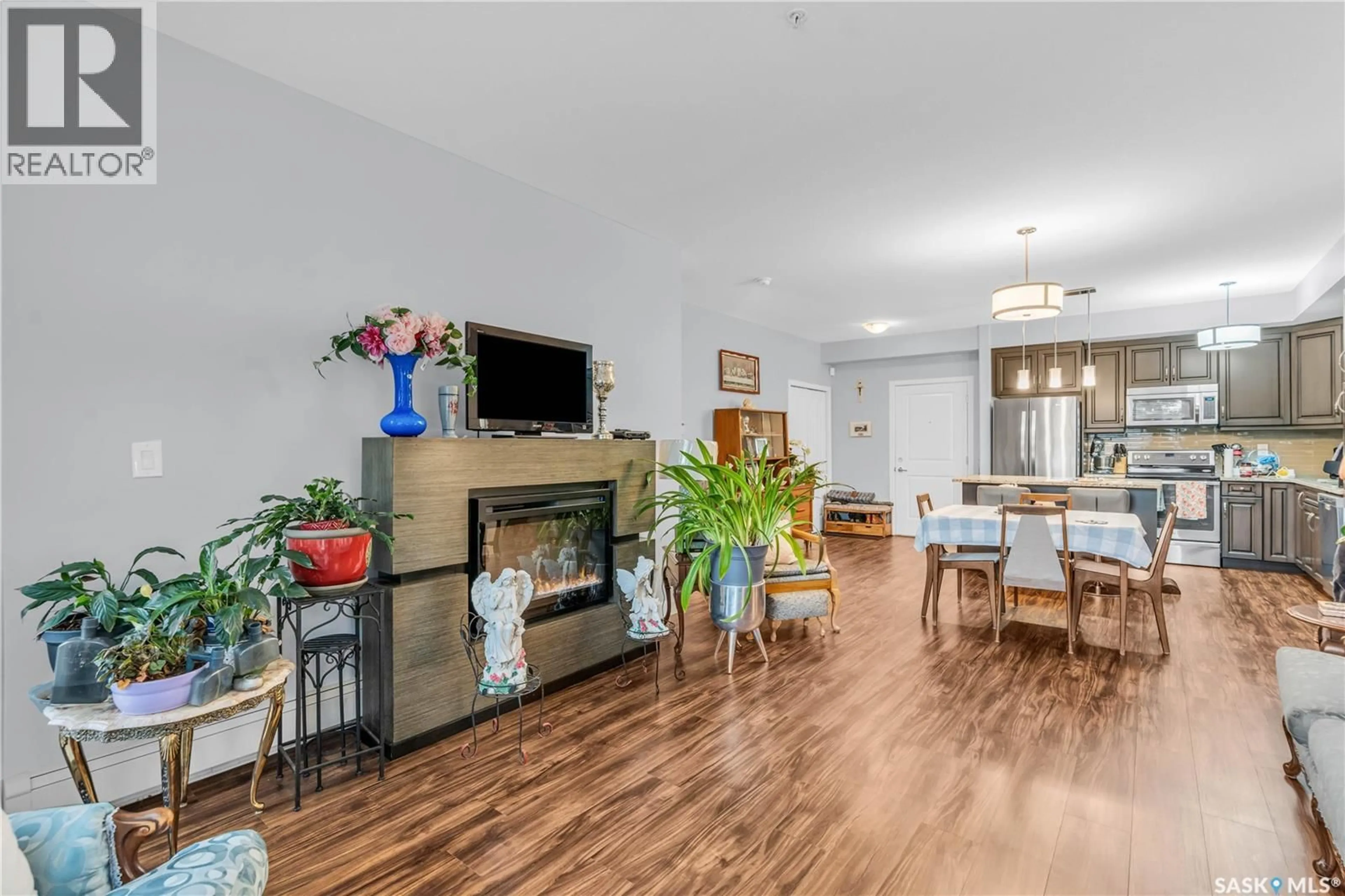 Living room with furniture, wood/laminate floor for 208 - 1025 MOSS AVENUE, Saskatoon Saskatchewan S7H4C7