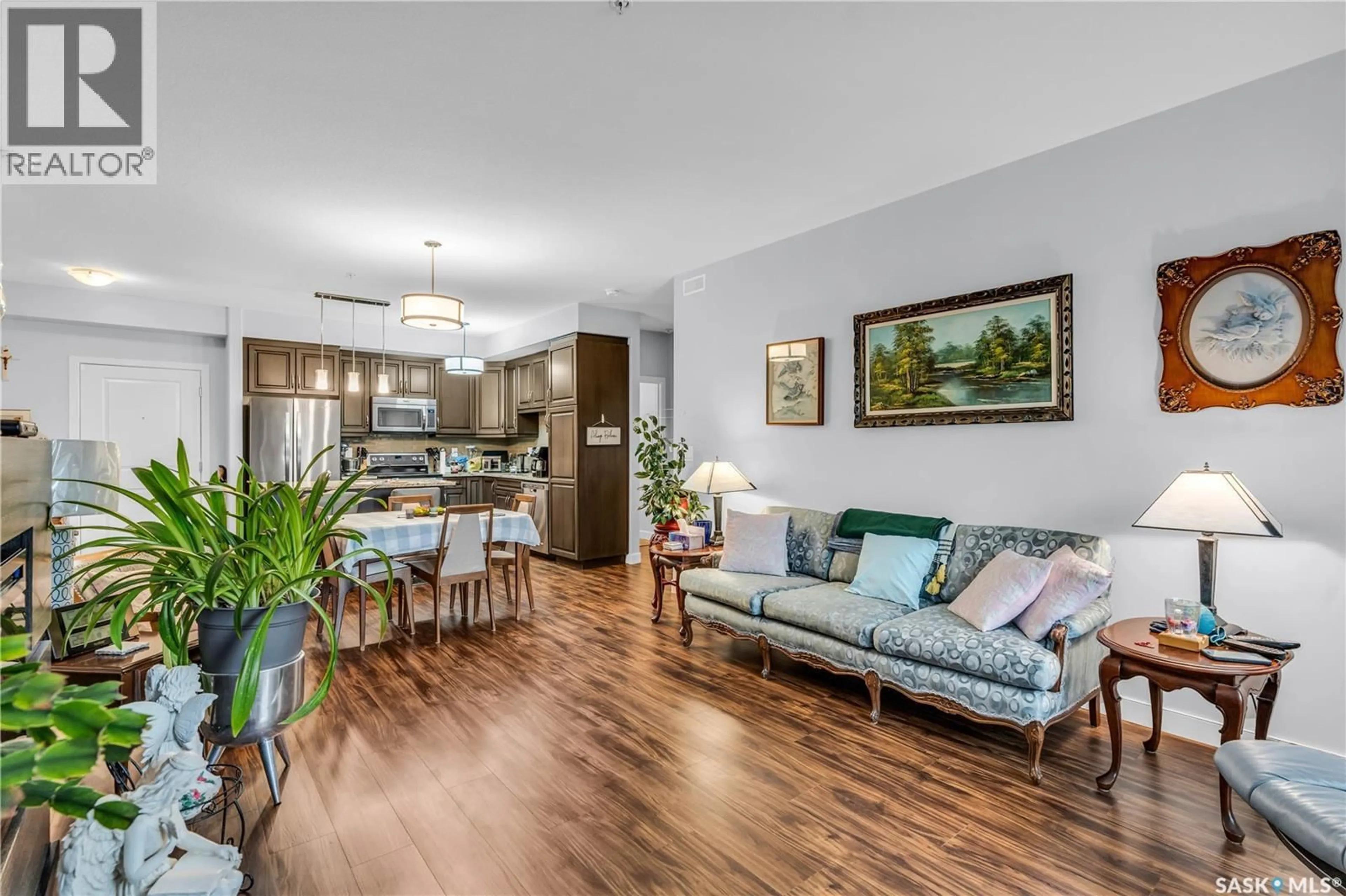 Living room with furniture, wood/laminate floor for 208 - 1025 MOSS AVENUE, Saskatoon Saskatchewan S7H4C7