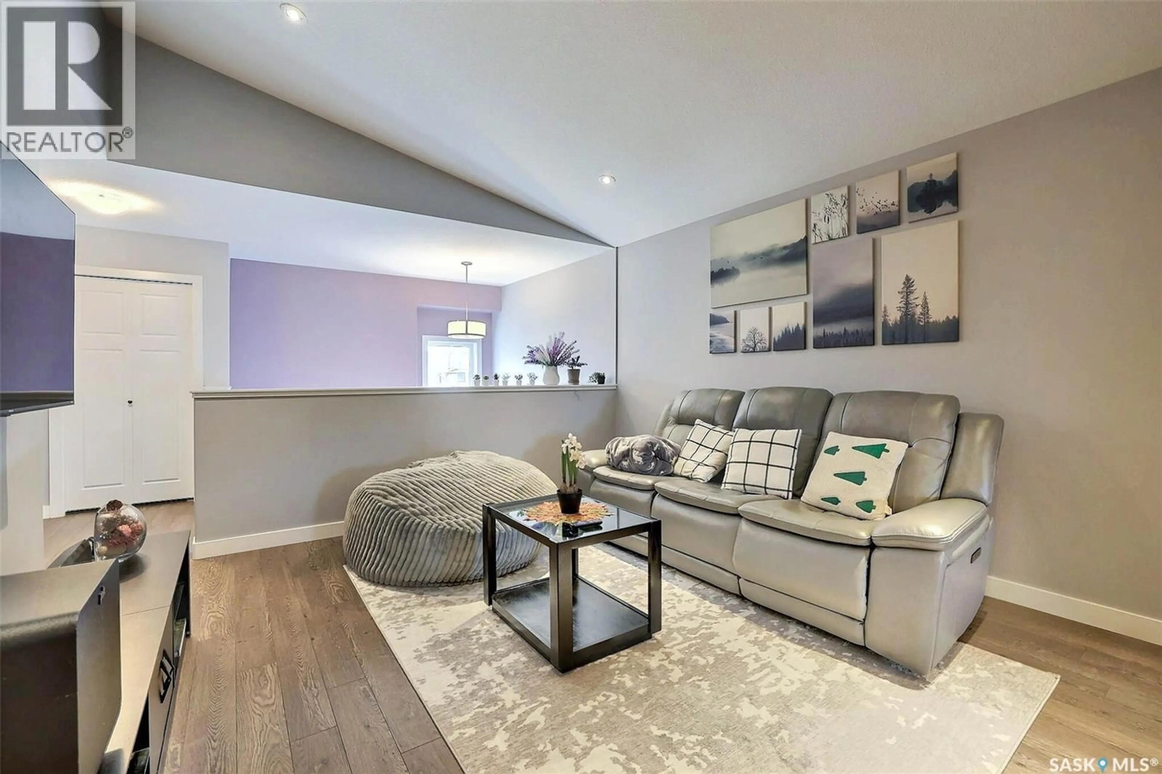 Living room with furniture, wood/laminate floor for E - 4165 GREEN APPLE DRIVE, Regina Saskatchewan S4V1S1