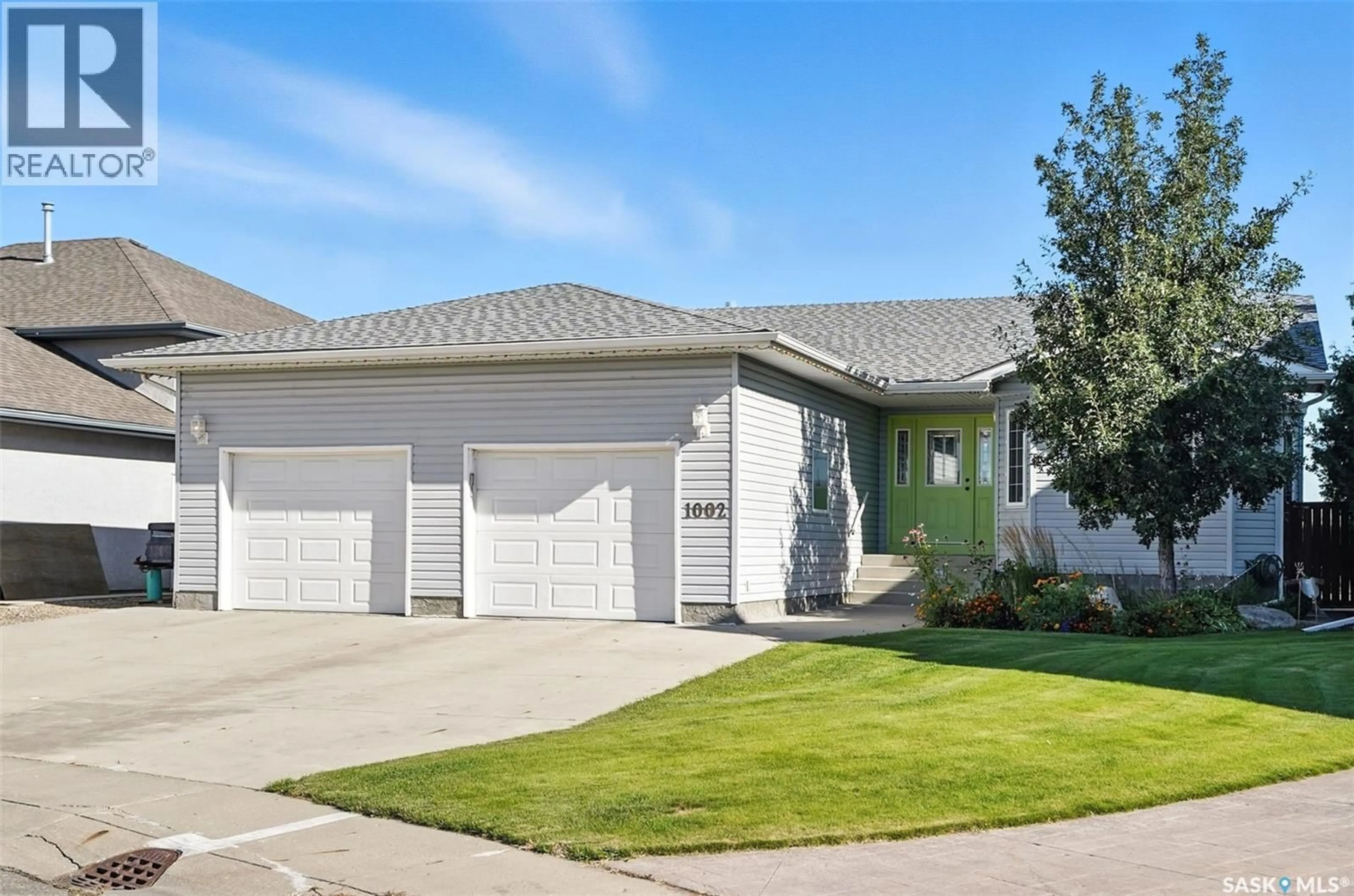 Home with vinyl exterior material, street for 1002 CARR CRESCENT, Saskatoon Saskatchewan S7S1L9