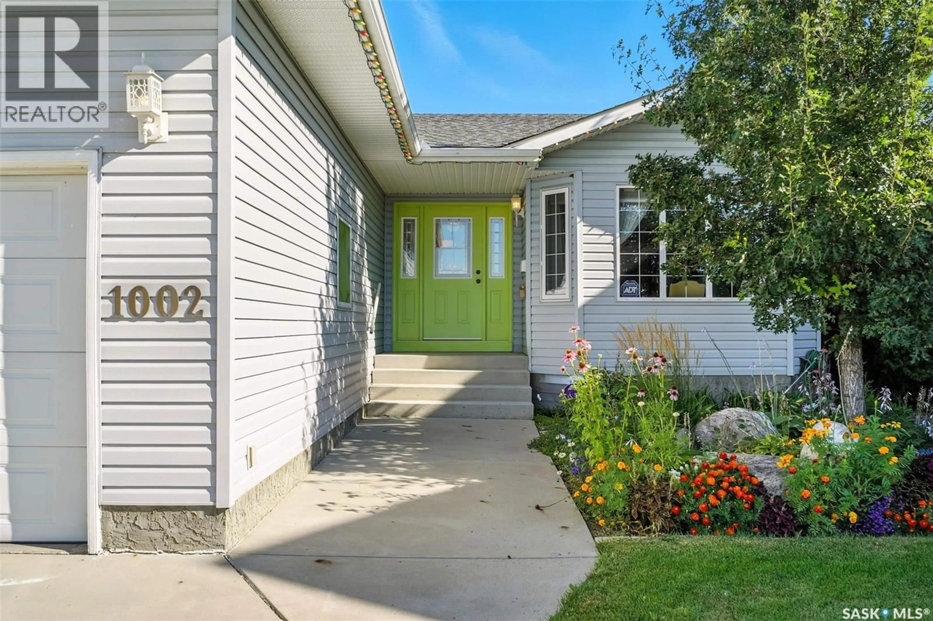 Home with vinyl exterior material, street for 1002 CARR CRESCENT, Saskatoon Saskatchewan S7S1L9