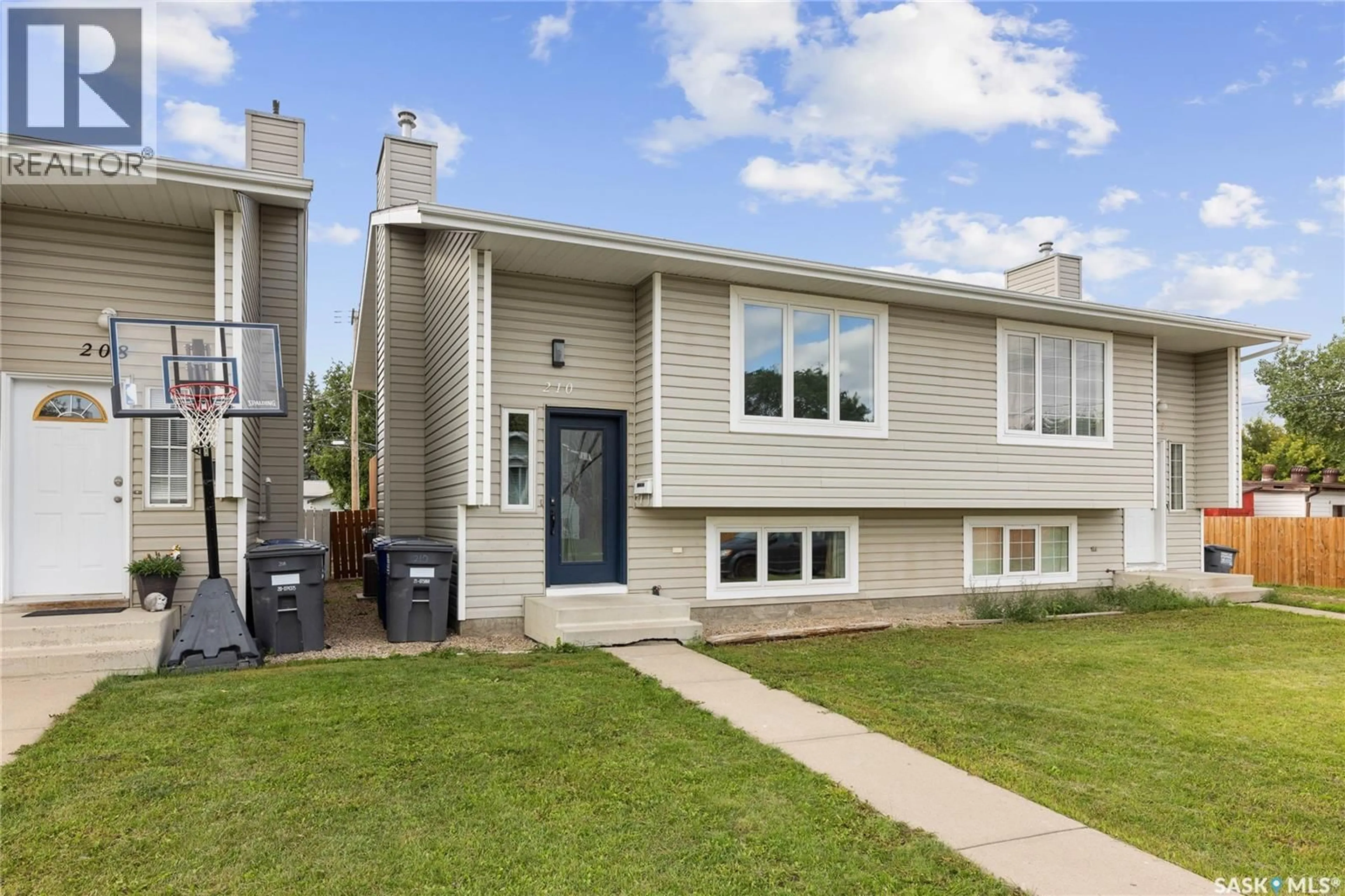 Home with vinyl exterior material, street for 210 HEDLEY STREET, Saskatoon Saskatchewan S7N1Z9