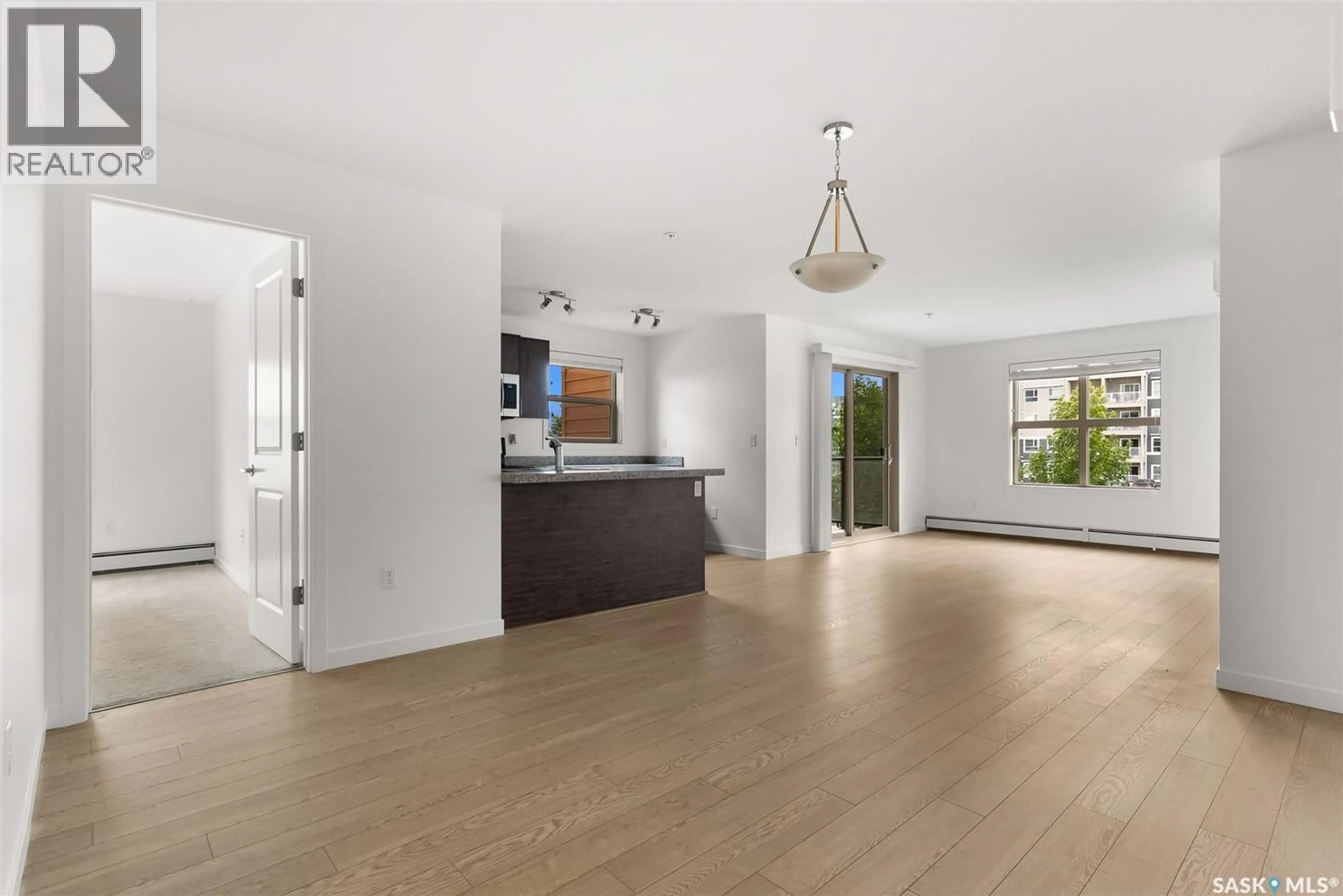Open concept kitchen, wood/laminate floor for 5500 - 1201 MITCHINSON WAY, Regina Saskatchewan S4W0N9