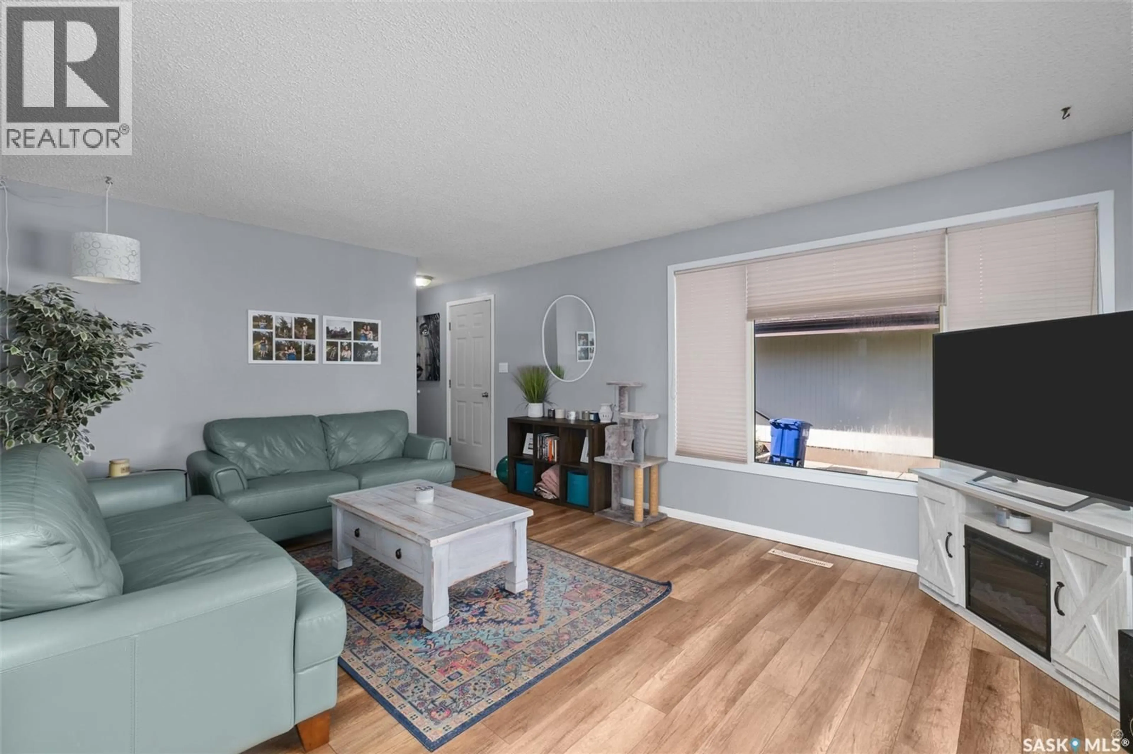 Living room with furniture, wood/laminate floor for 851 20TH STREET, Prince Albert Saskatchewan S6V4H5
