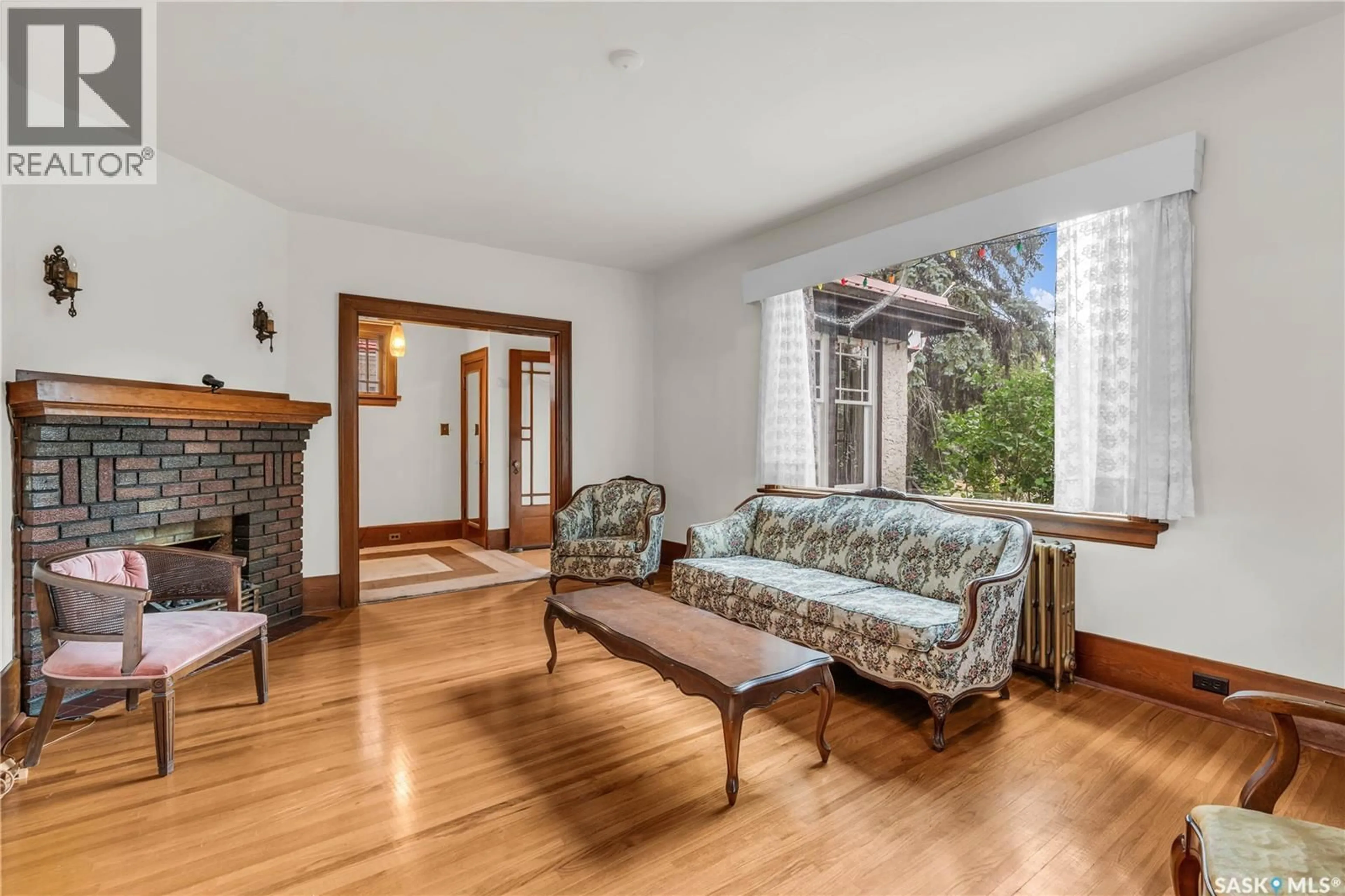 Living room with furniture, wood/laminate floor for 3208 COLLEGE AVENUE, Regina Saskatchewan S4T1V9
