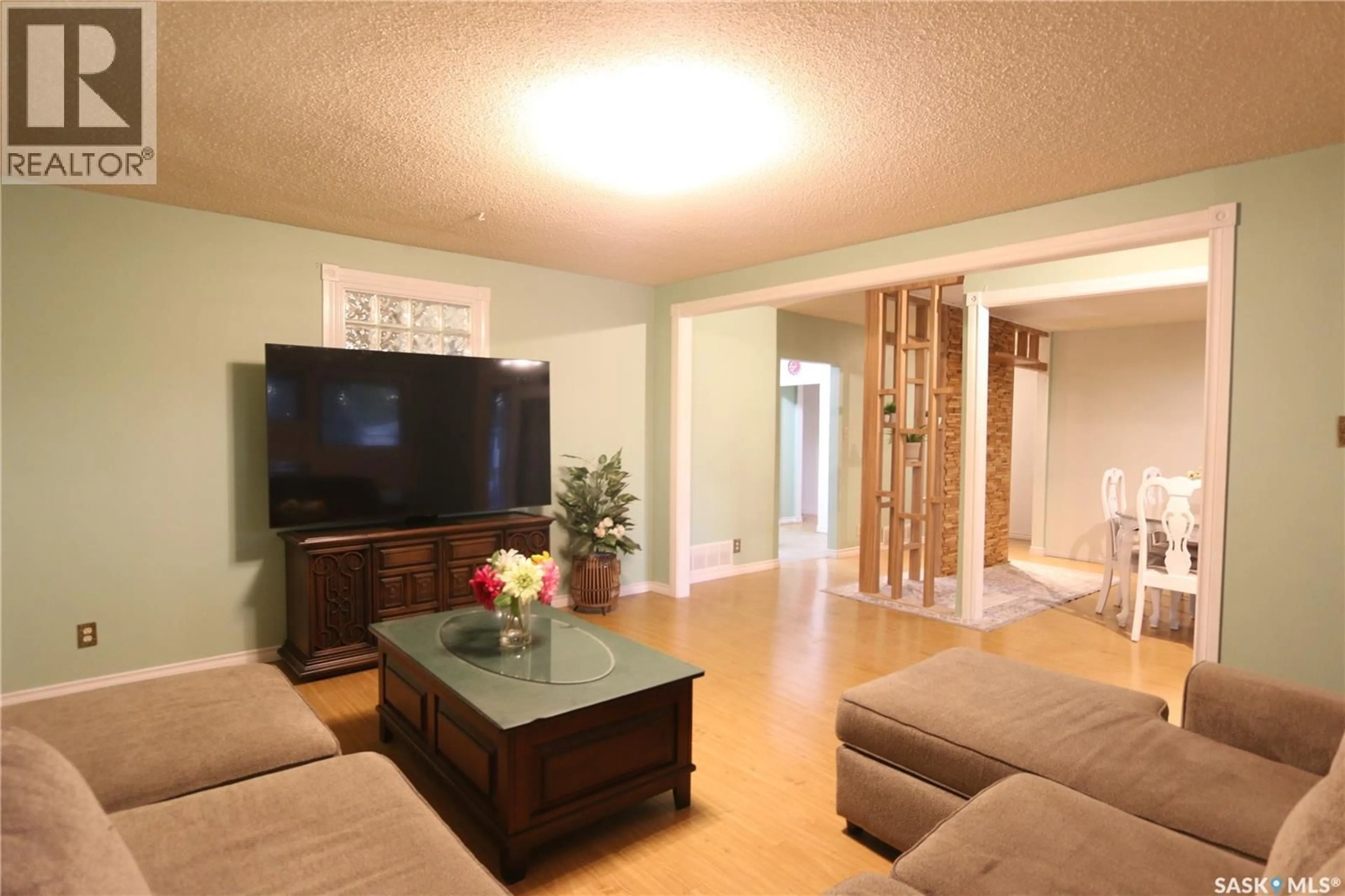 Living room with furniture, wood/laminate floor for 1500 MACPHERSON AVENUE, Regina Saskatchewan S4S4C9