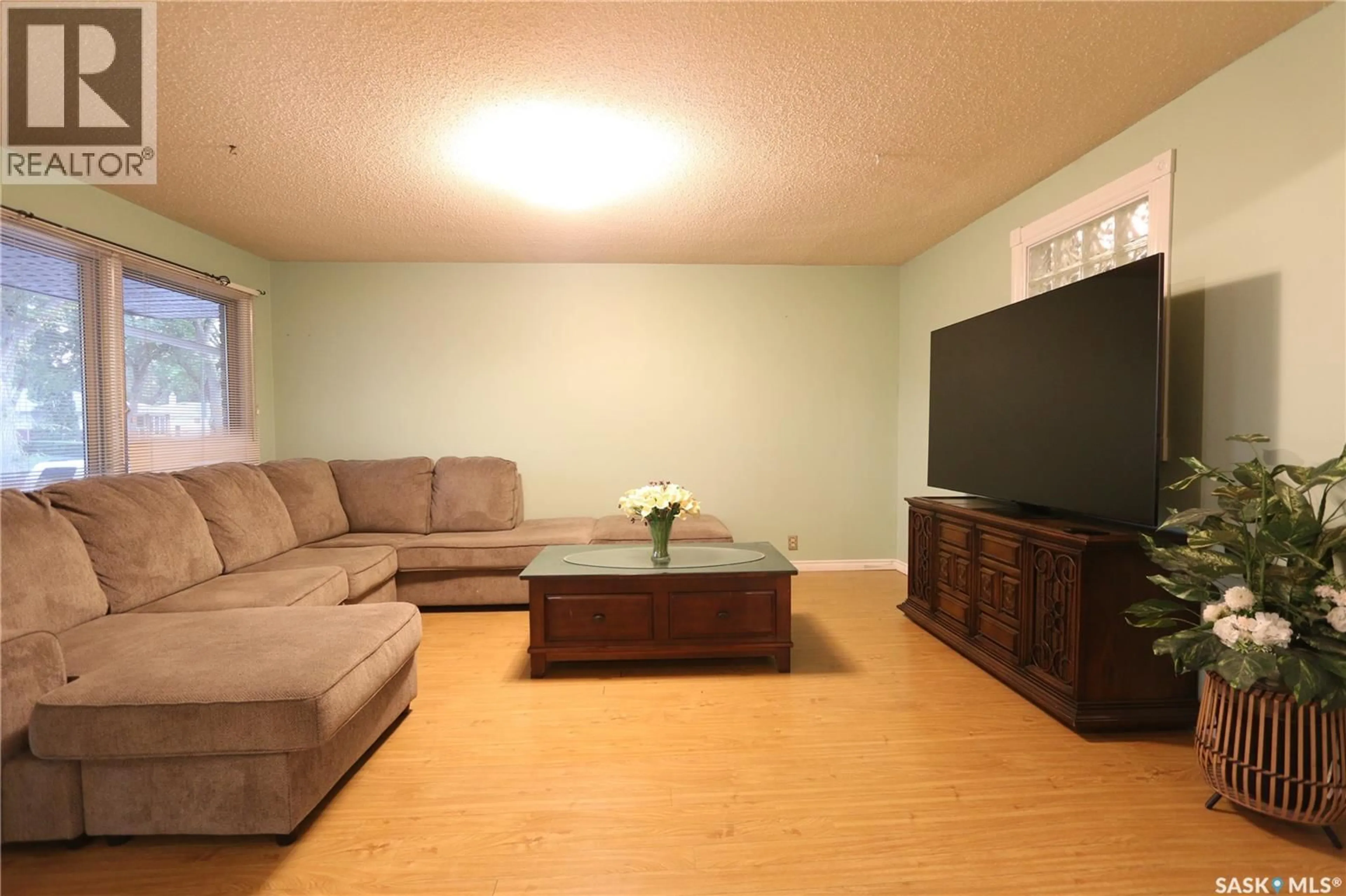 Living room with furniture, wood/laminate floor for 1500 MACPHERSON AVENUE, Regina Saskatchewan S4S4C9