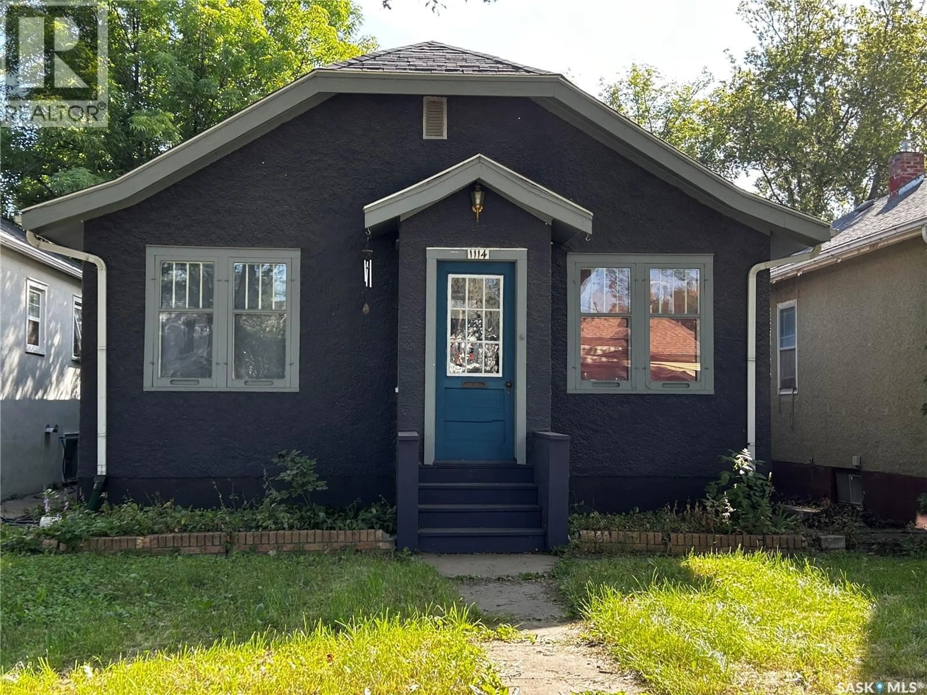 Home with vinyl exterior material, street for 1114 C AVENUE, Saskatoon Saskatchewan S7L1K4