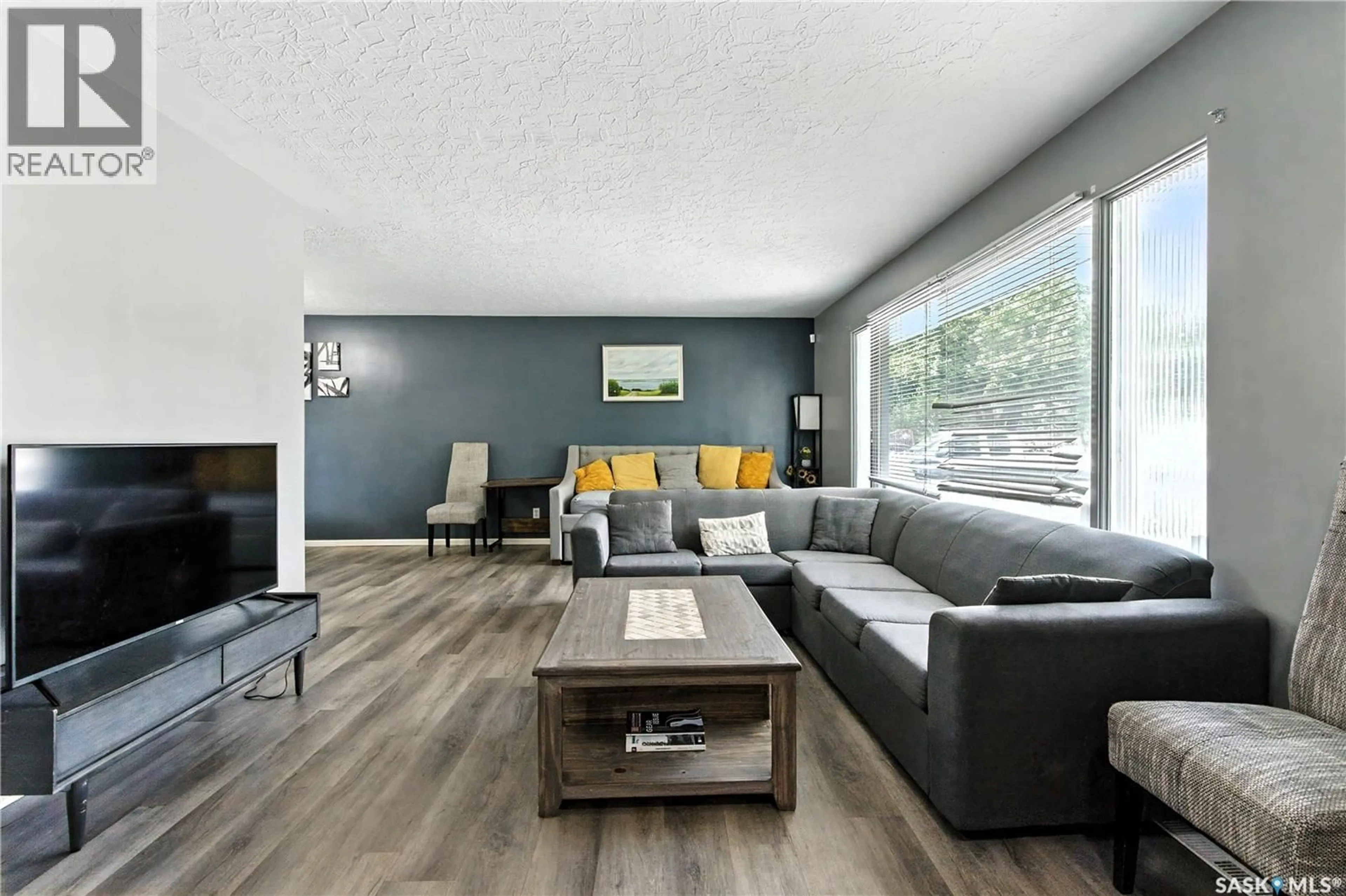 Living room with furniture, wood/laminate floor for 1426 10TH STREET, Saskatoon Saskatchewan S7H0J5